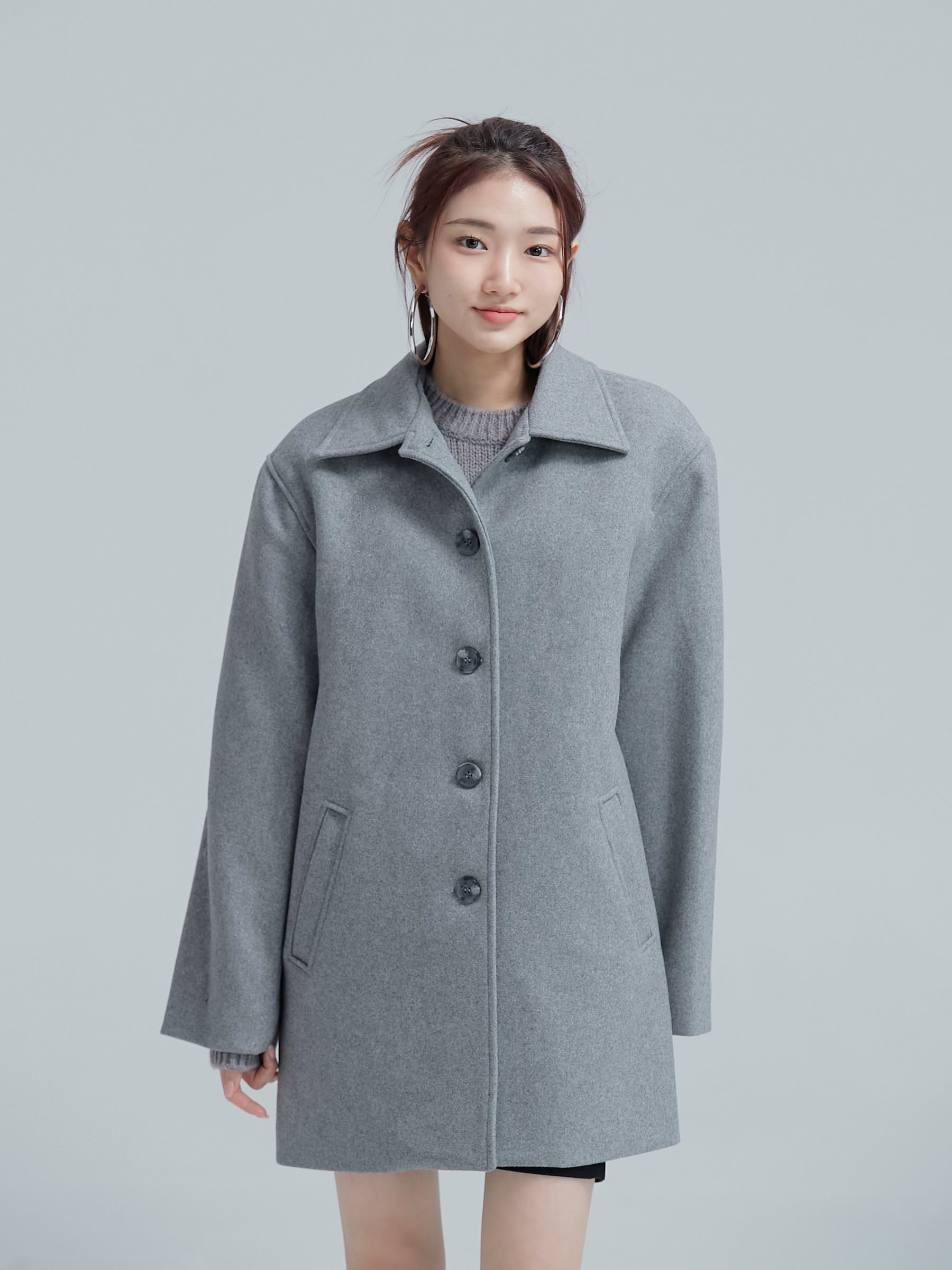 The model facing front wearing the gray 100% Wool coat showing its korean style aesthetics.