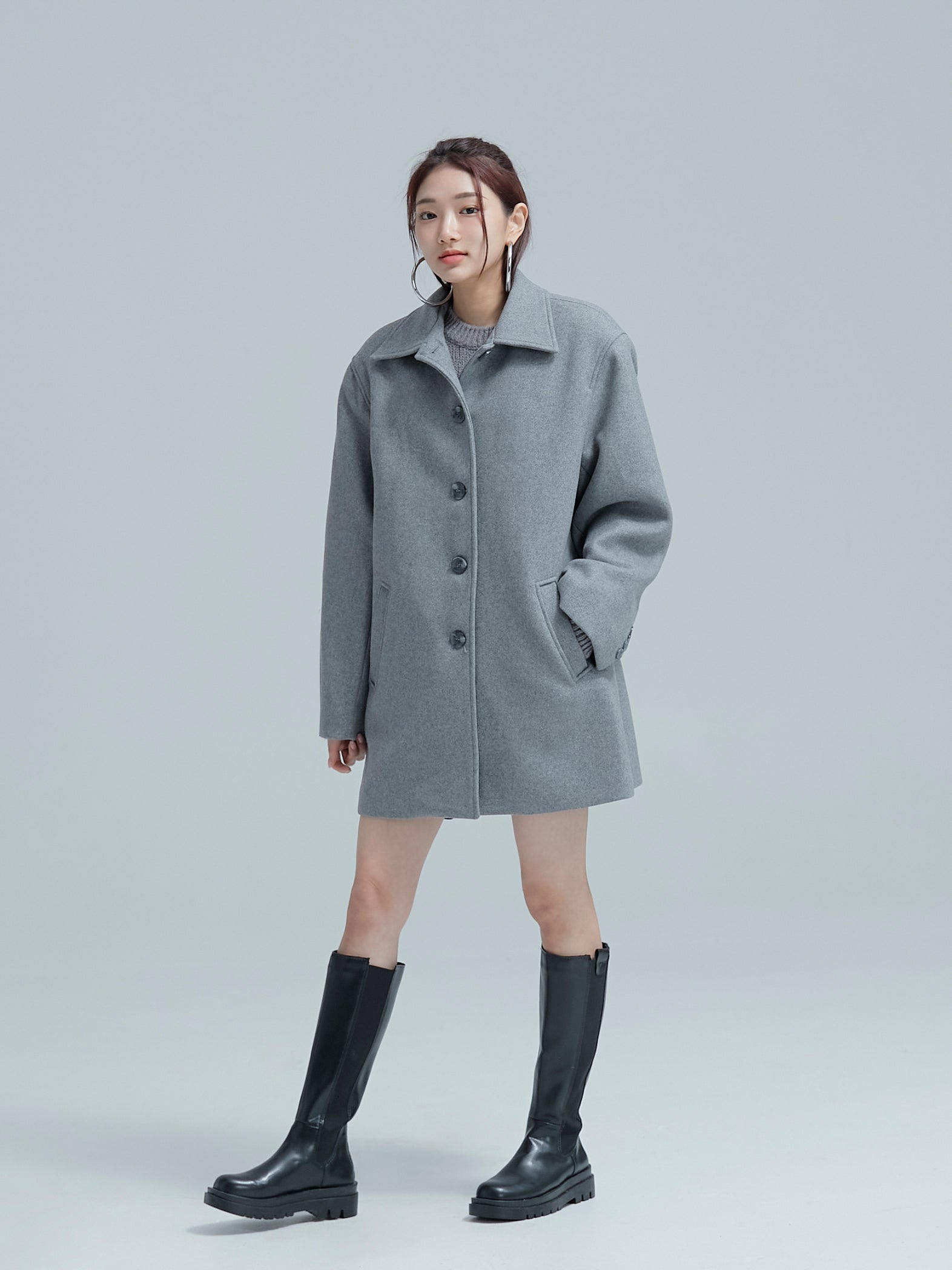 The model strikes a casual pose adorned in a 100% wool coat, embodying the allure of Korean aesthetic outfits.