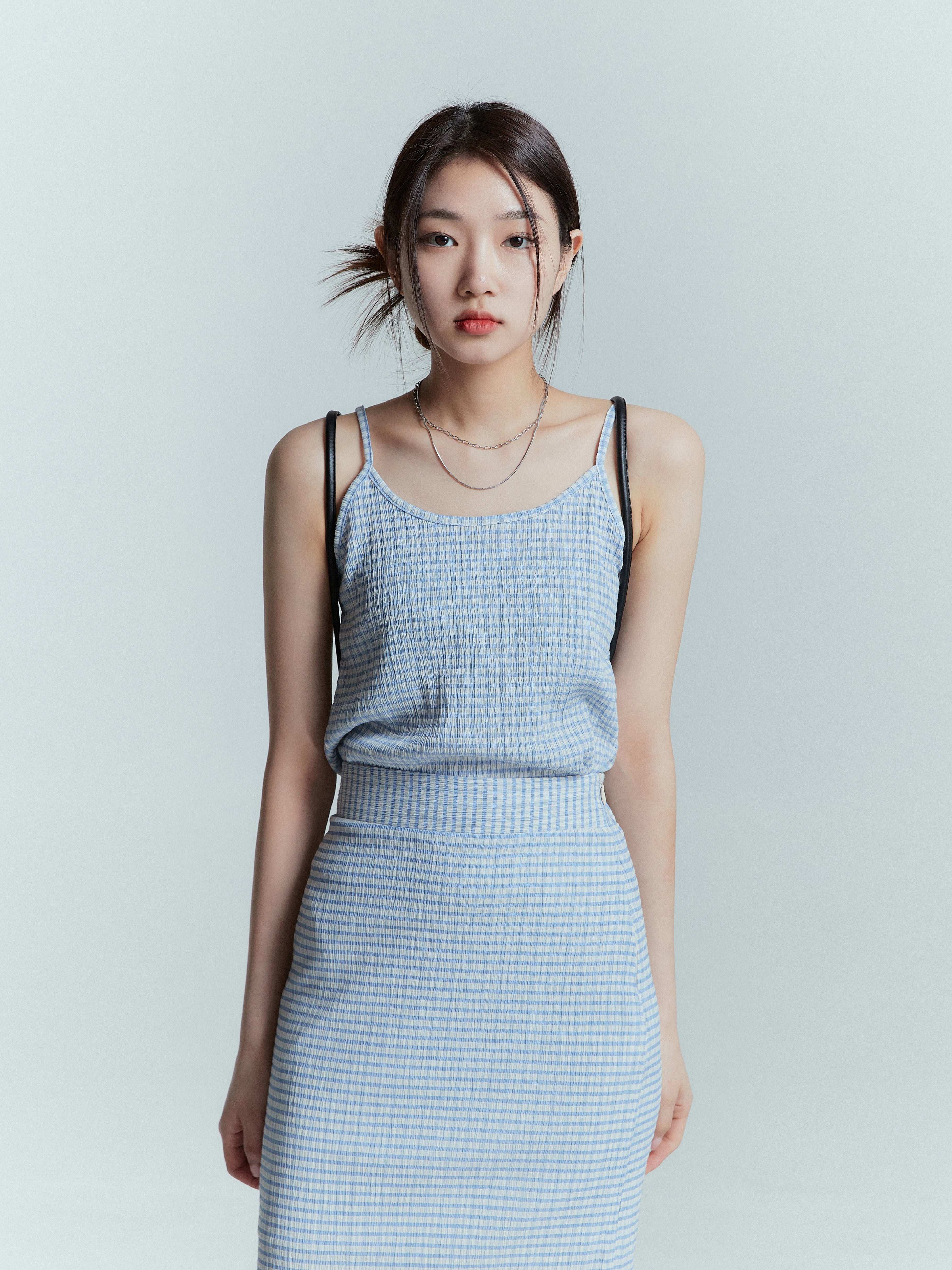 Front shot of the model wearing the plaid sleeveless tank top showcasing the front side of the top.