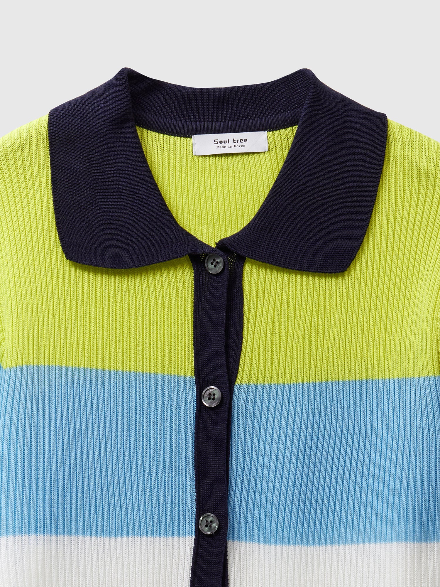 A closed-up look of the colorblock knit sweater highlighting the product design details of the colorblock and collars.