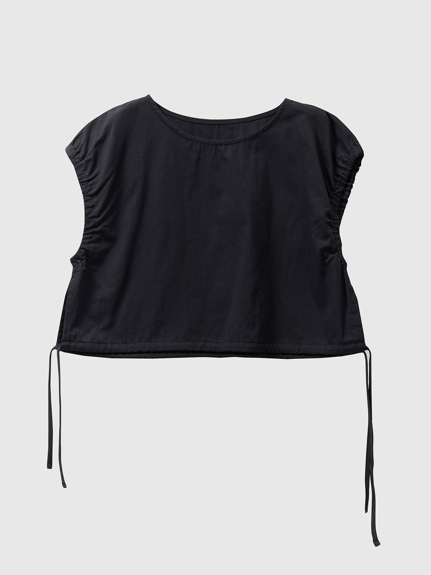 Front view of the black elastic waist crop top with white backdrop.