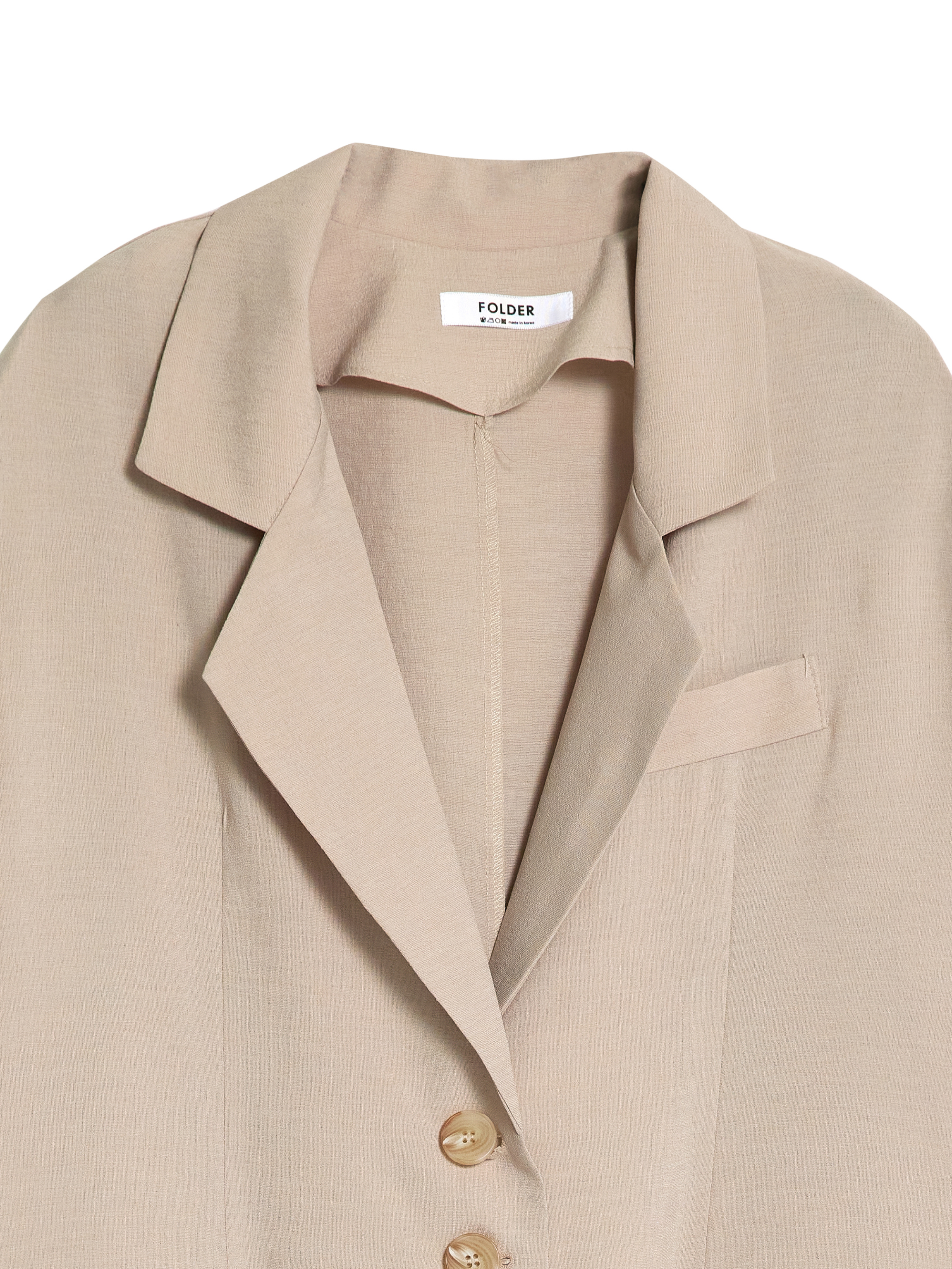 A close-up shot of the the short-sleeve coat showcasing the intricate detail of the lapel collar and the buttons.