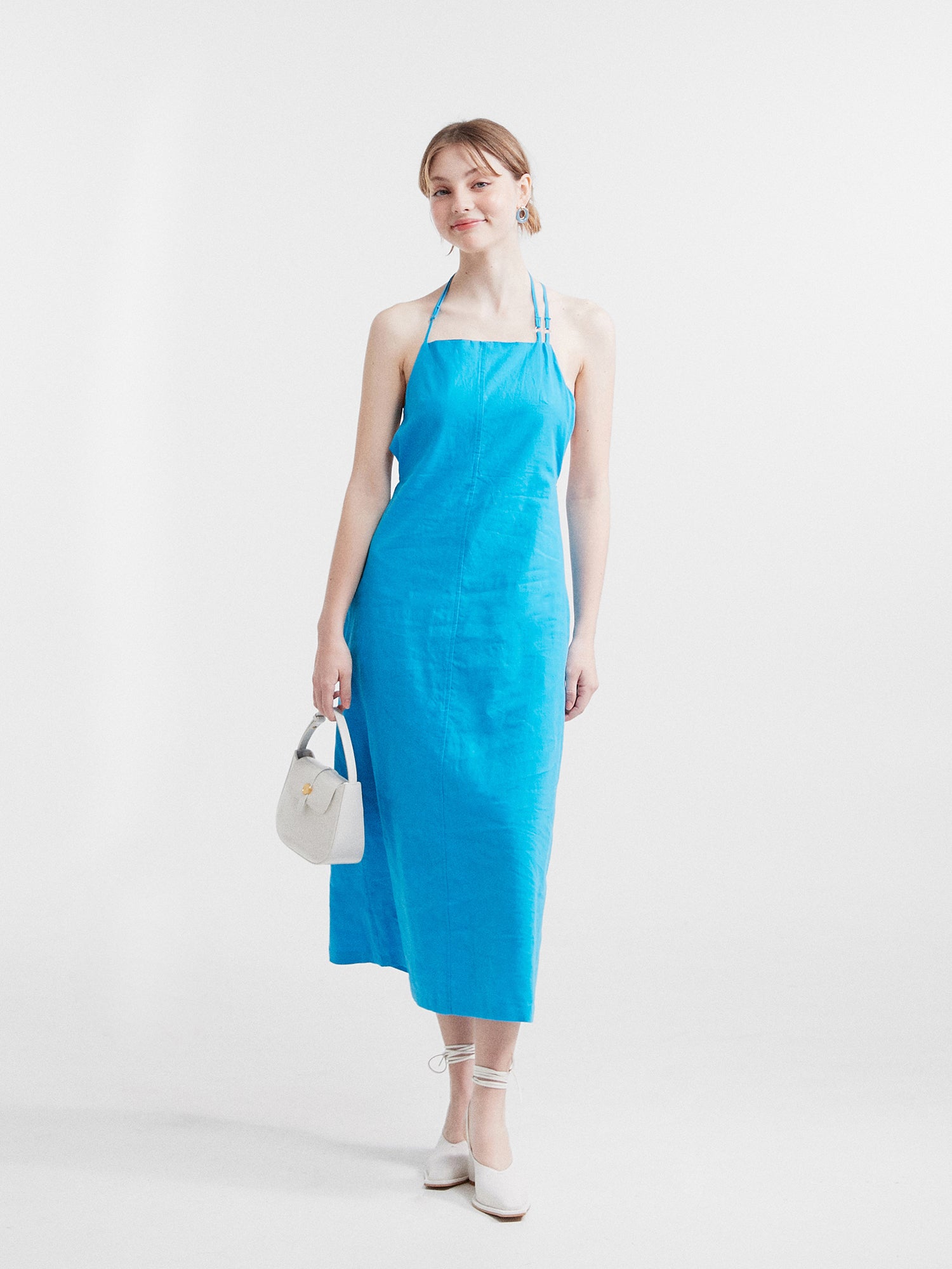 Model standing wearing the blue backless midi dress that is perfect for k-fashion summer.