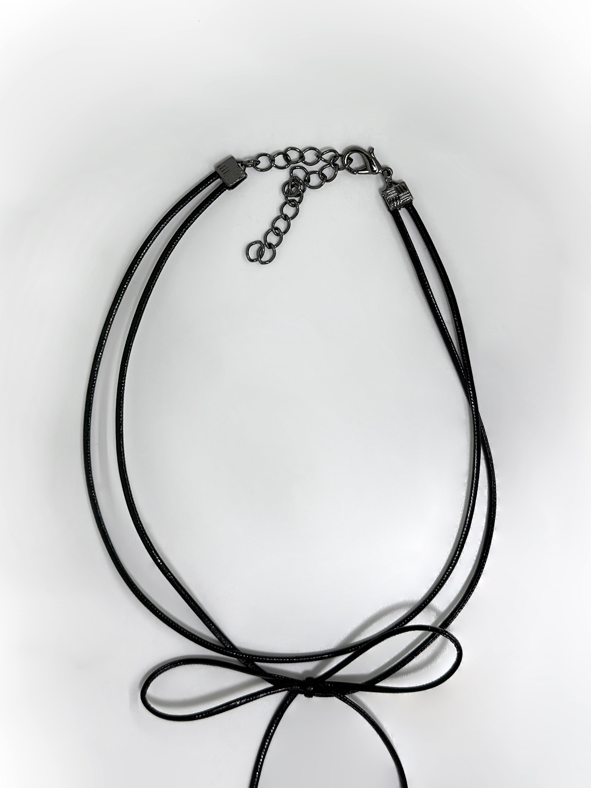 A detailed view of the black knot necklace showing the clasps detail of the necklace.