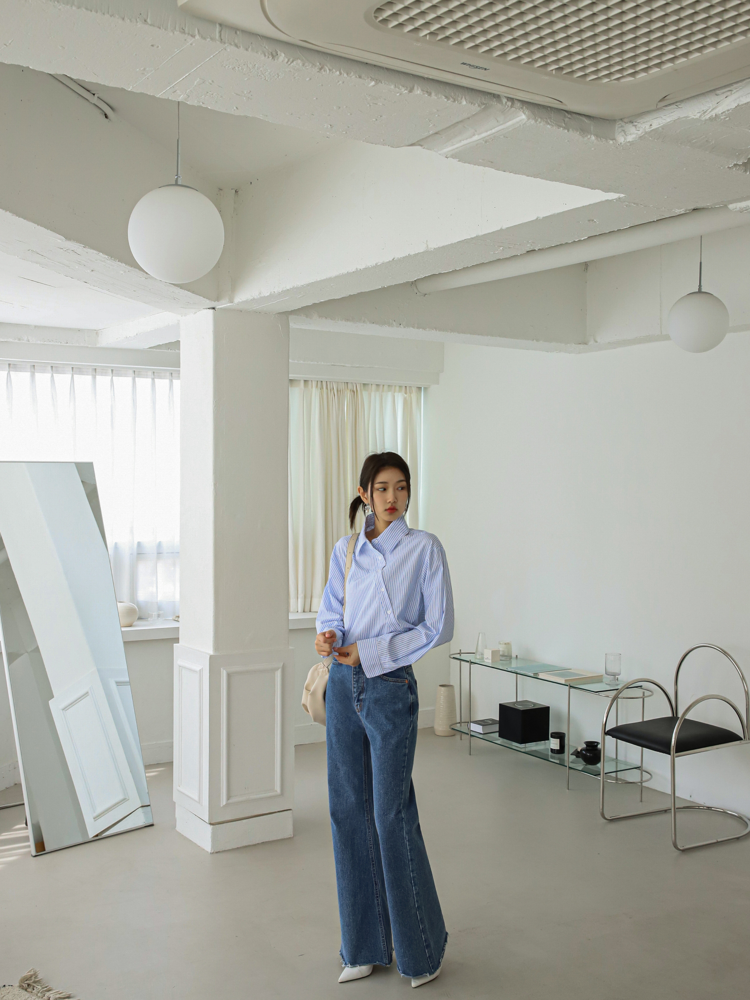 An angled shot of the model wearing the bootcut jeans, highlighting a unique perspective and providing a different angle to showcase the jeans.