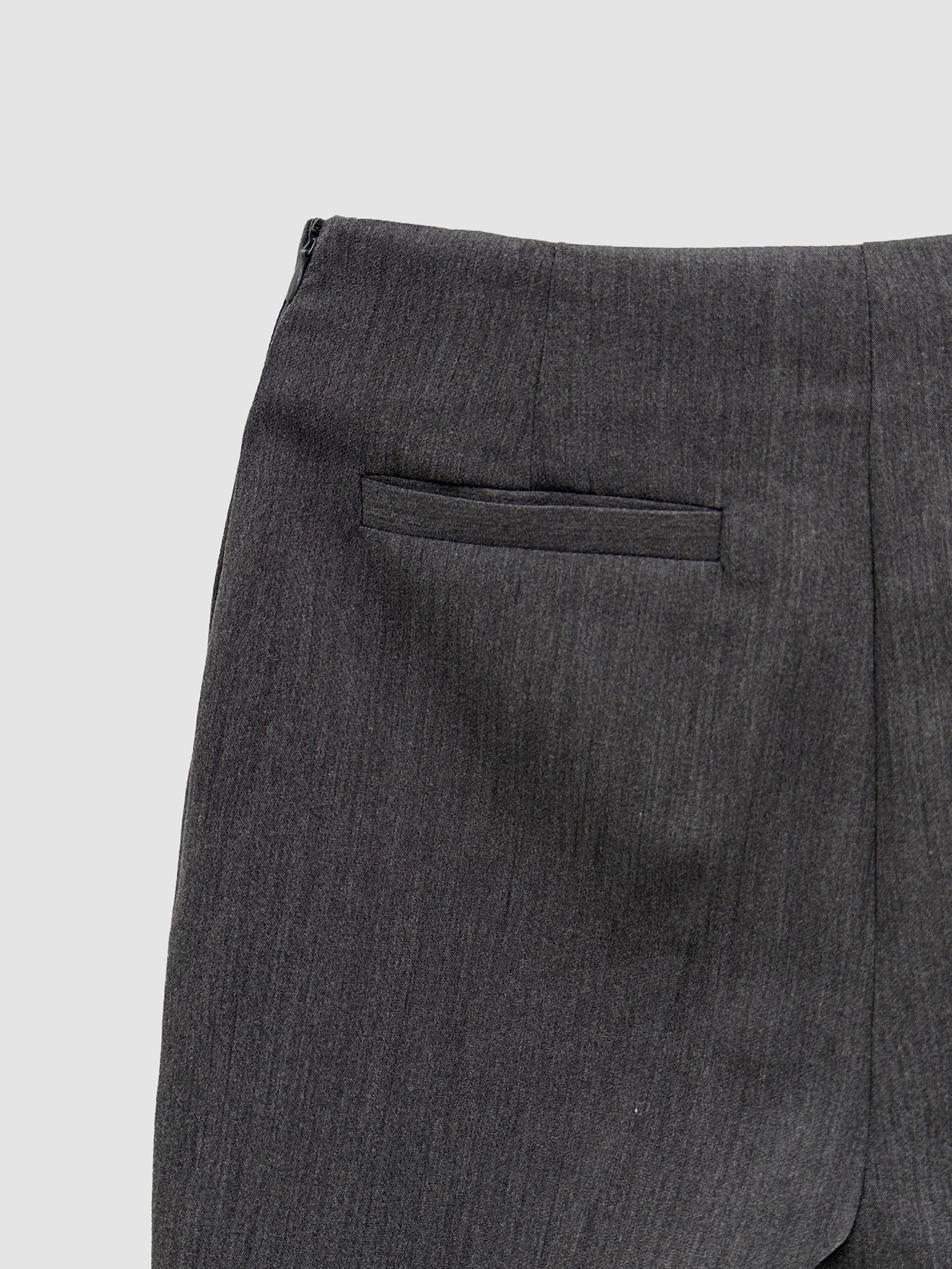 A zoomed-in view of the bootcut trouser showing the texture of the fabric and seam stitchings of the trouser.