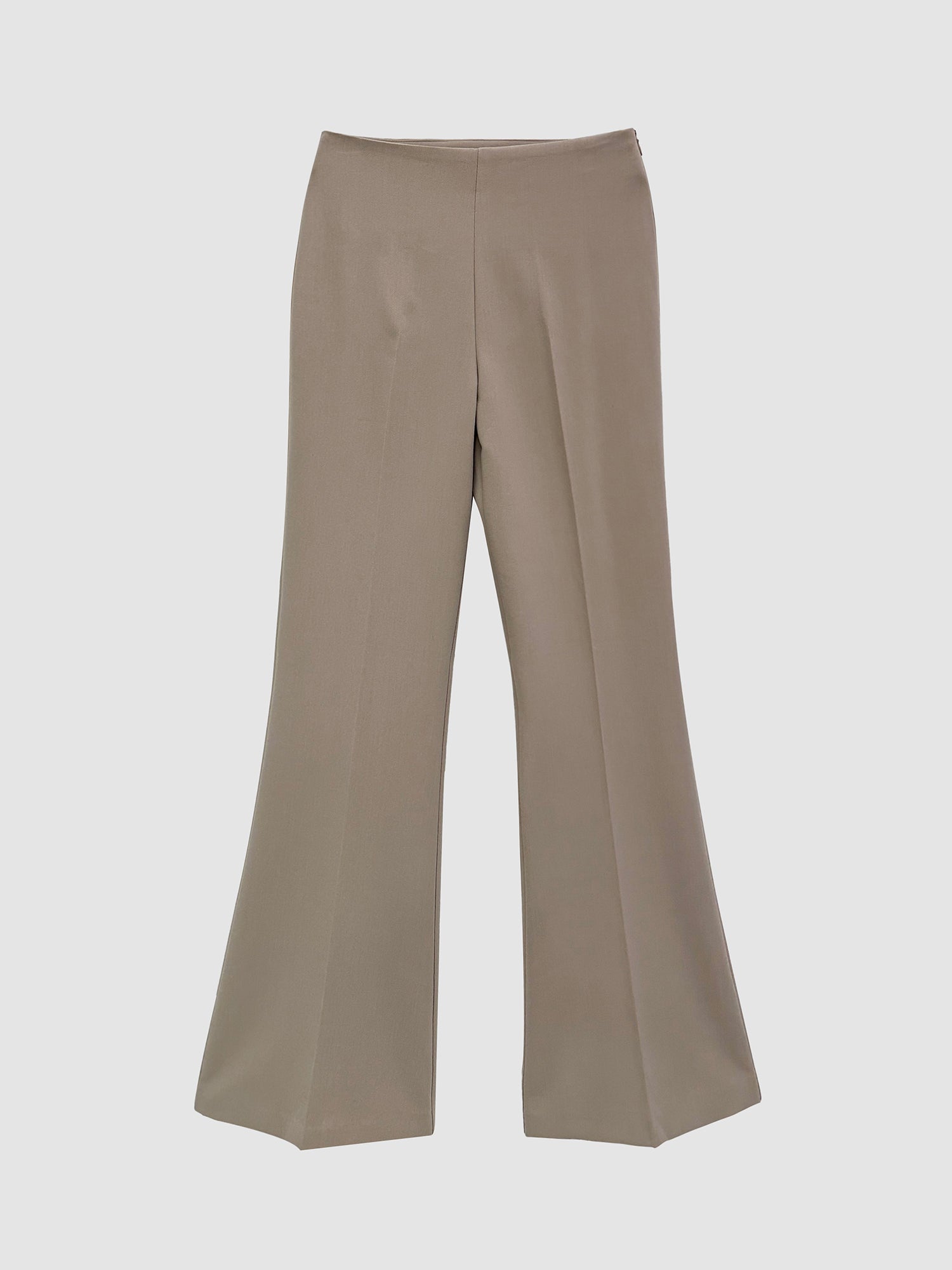 A close and detailed look at the front of the beige bootcut trousers, highlighting the intricate design elements.