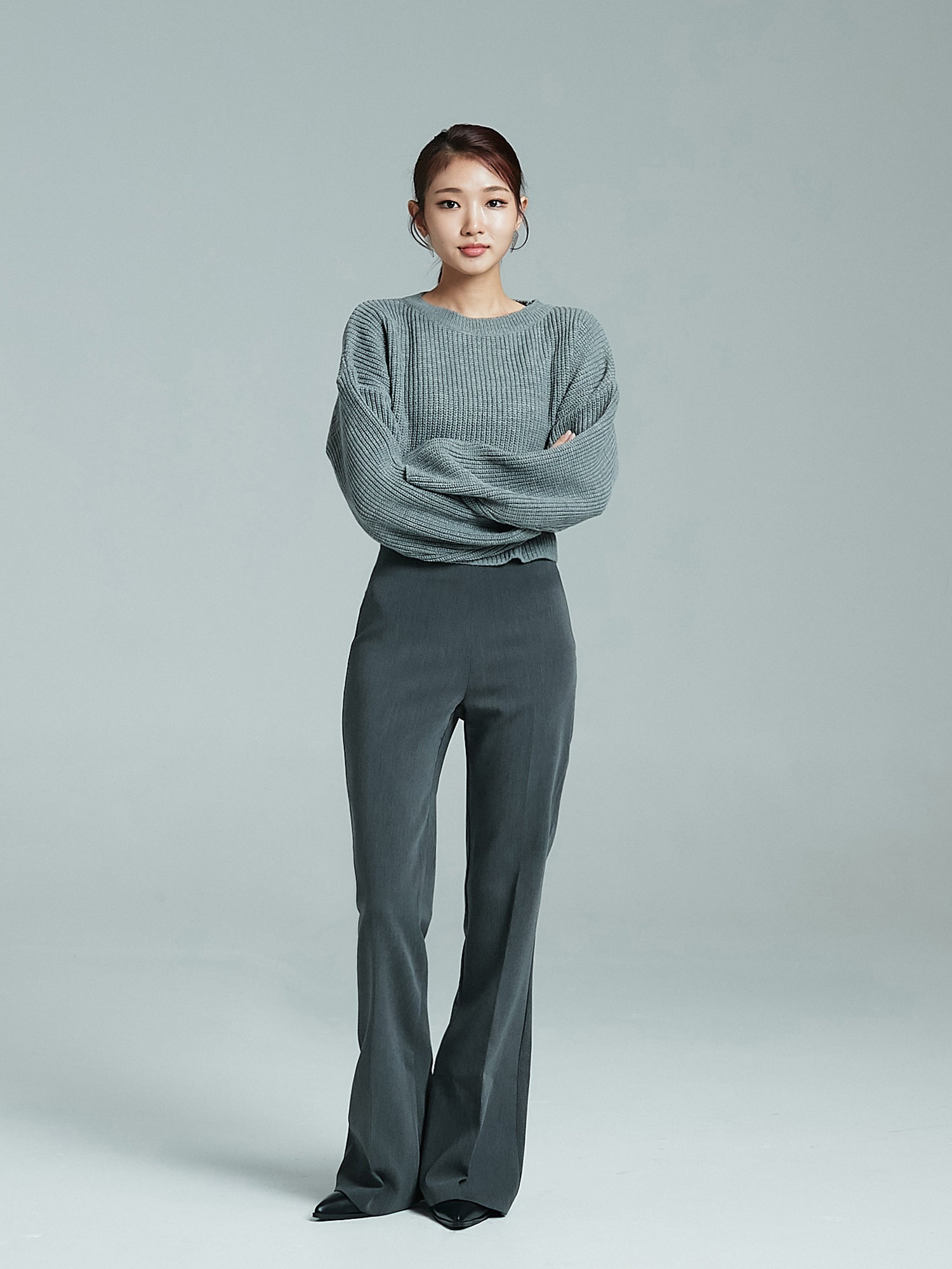 Full shot of the model posing while wearing the bootcut trouser to showcase its korean street style vibe.