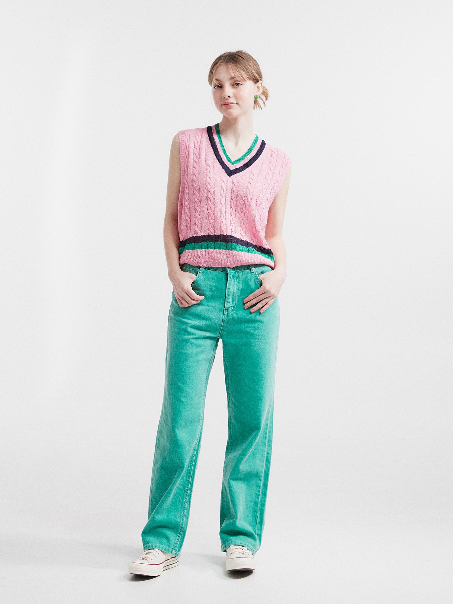 Front view of the model, embodying Korean street style with confidence, while rocking a pair of ocean green carpenter jeans, adding a touch of urban flair to the overall look.