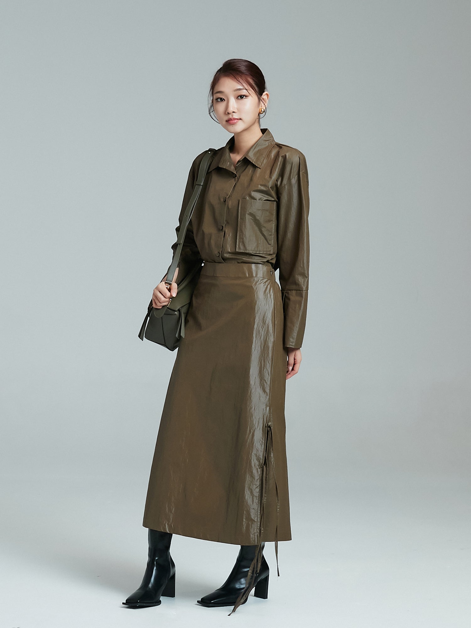 A tilted angle of the model wearing the coated shirt with pockets showcasing its korean aesthetic outfits look.