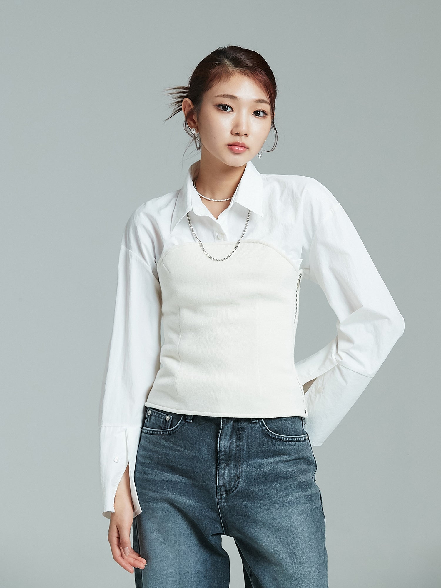 Front view of the model wearing the white coated shirt with pockets showcasing its korean street fashion.