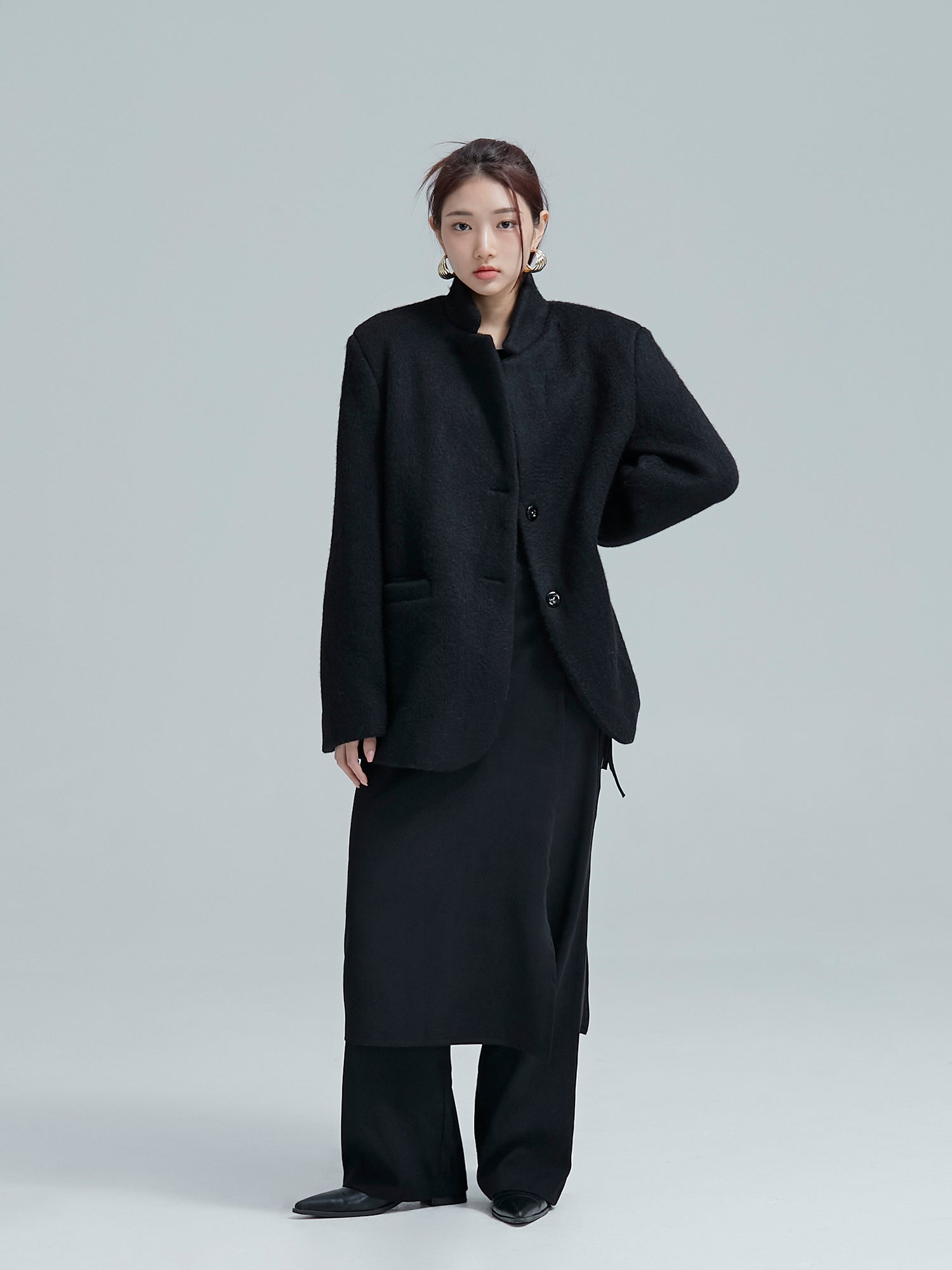 Full shot of the model wearing the cocoon jacket matched with wrap skirt pants to show its korean street fashion vibe.