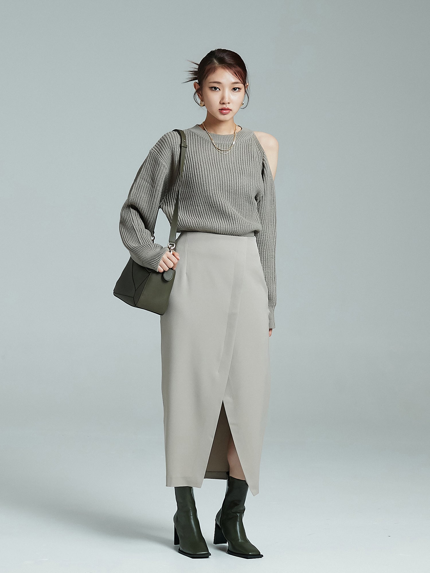 Full-shot of the model wearing the cold shoulder sweater paired with maxi skirt.