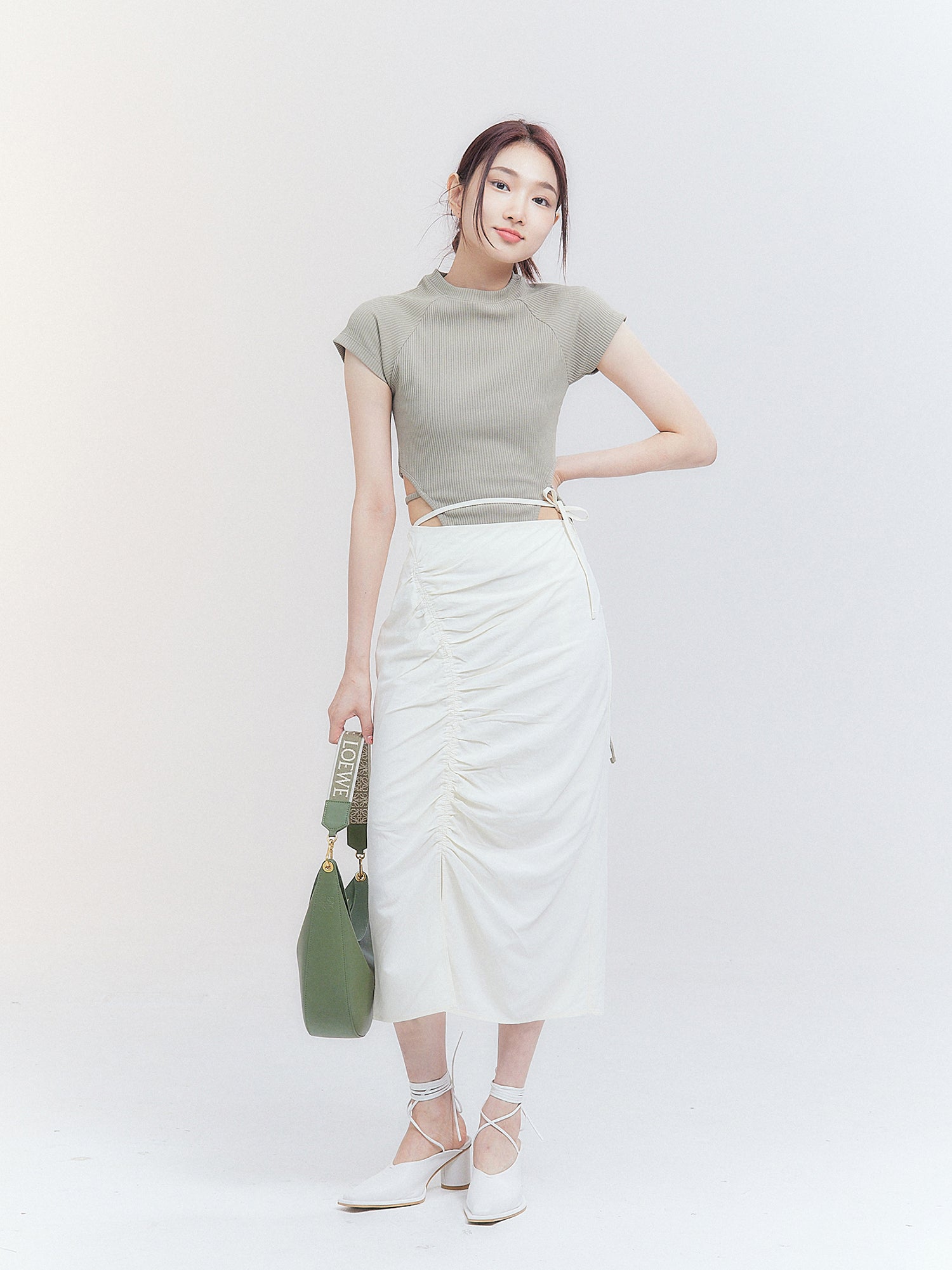 Full-length shot of the model wearing the crop top with strap showing the fitting of the garment.