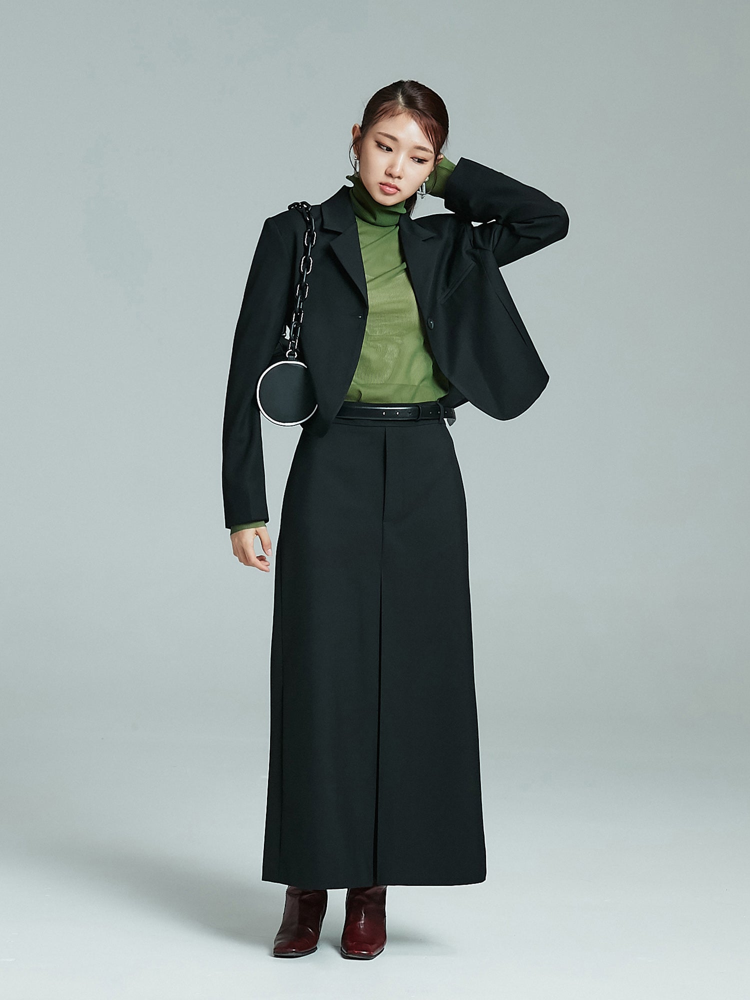 Take a full shot of the model exuding Korean street fashion flair while wearing the cropped blazer paired with a stylish maxi skirt.