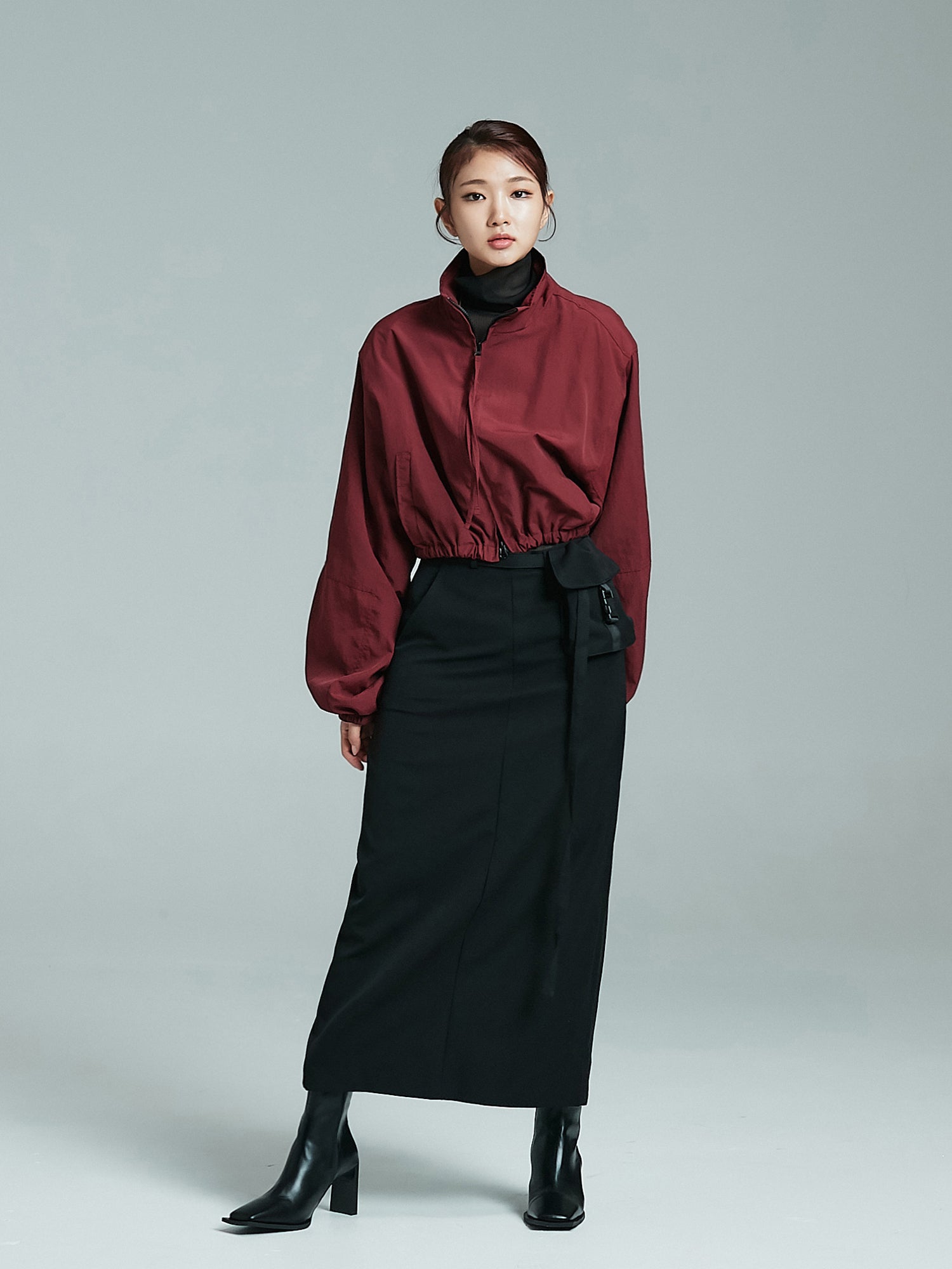 A full shot of the model in the cropped bomber jacket, radiating the chic essence of Korean street fashion.