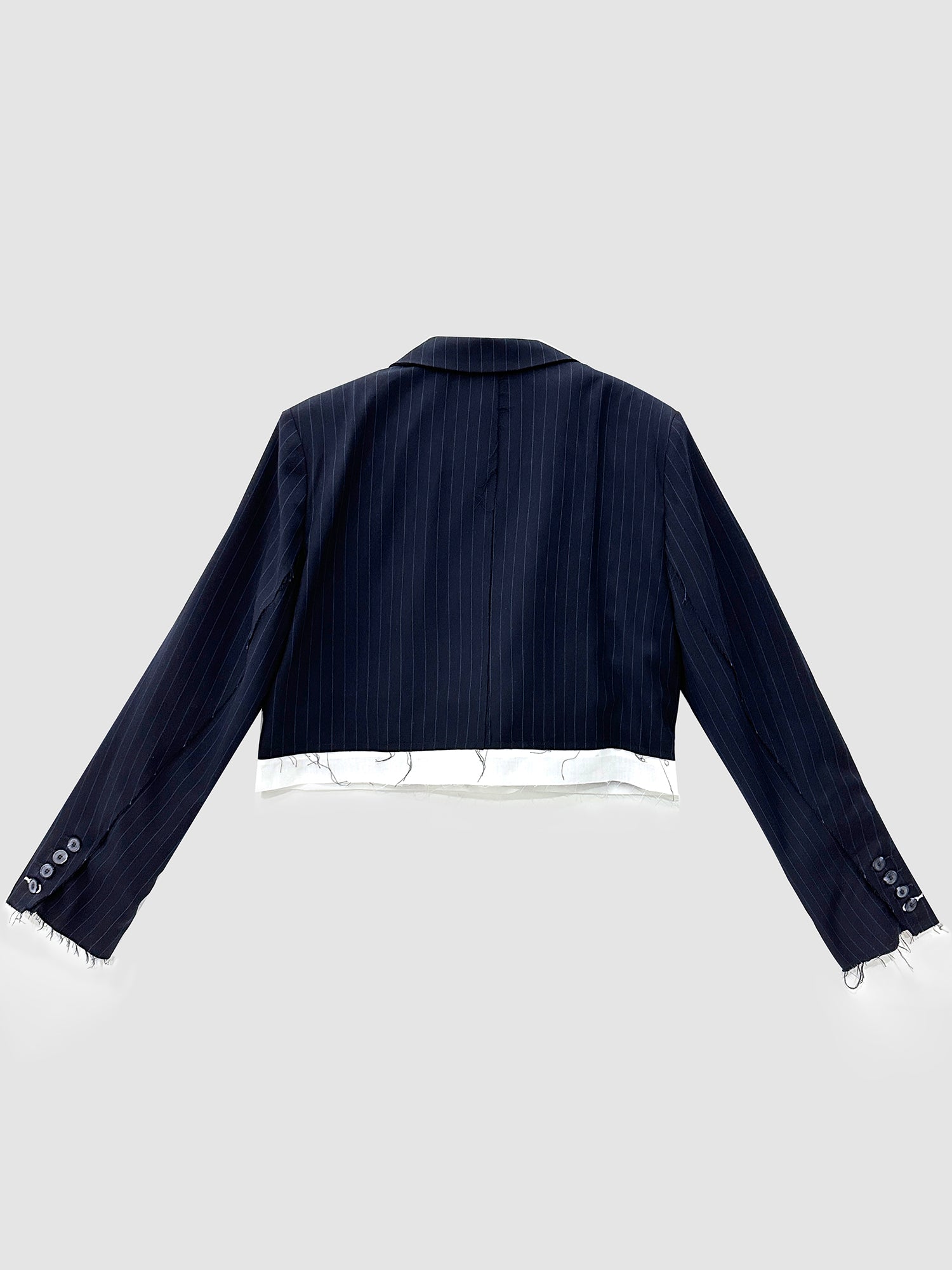 Back detailed view of the navy stripe cropped layered blazer showing its back fitting and design details.