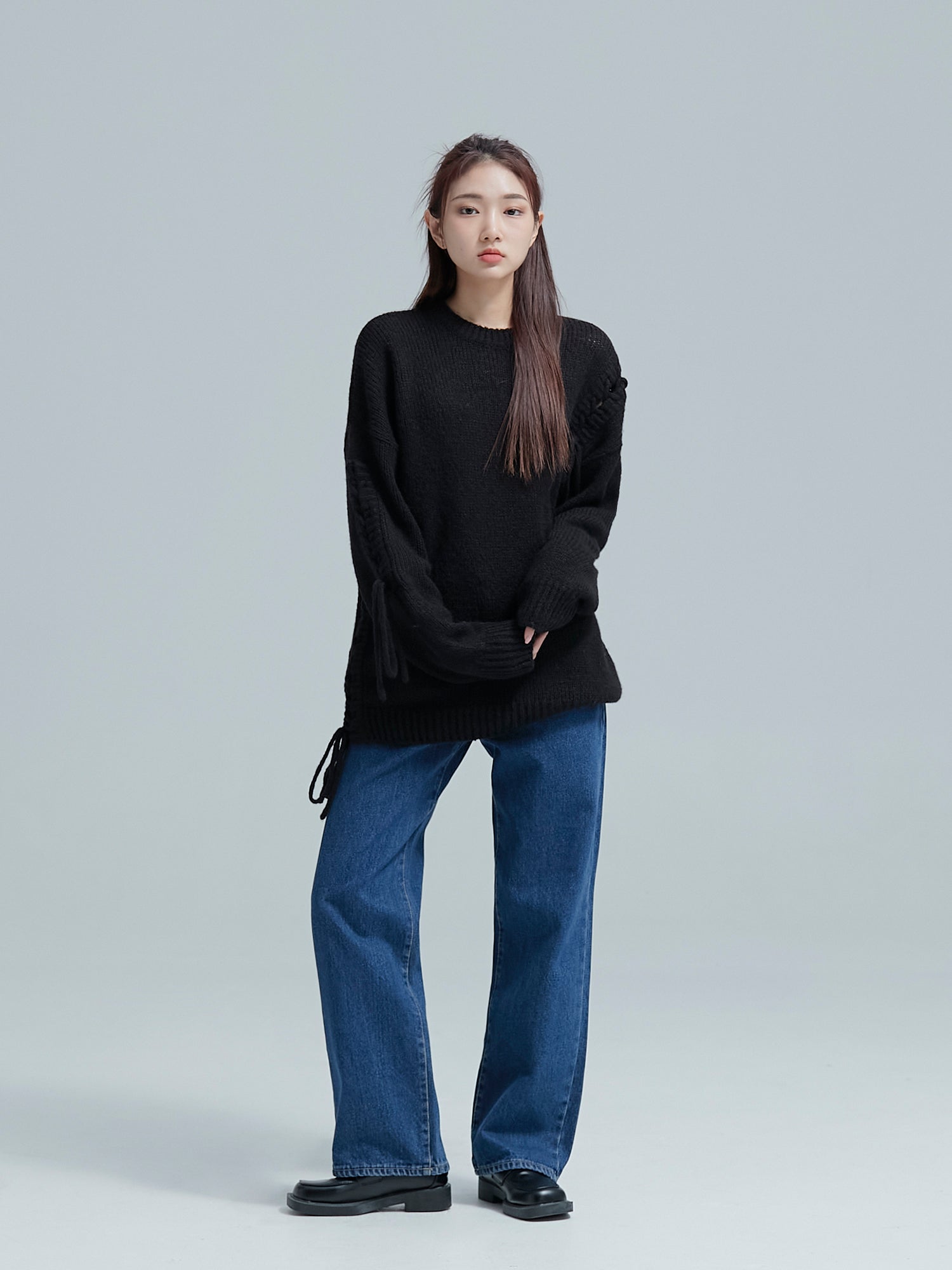 The model strikes a pose in denim jeans, capturing the essence of Korean street fashion with effortless style.