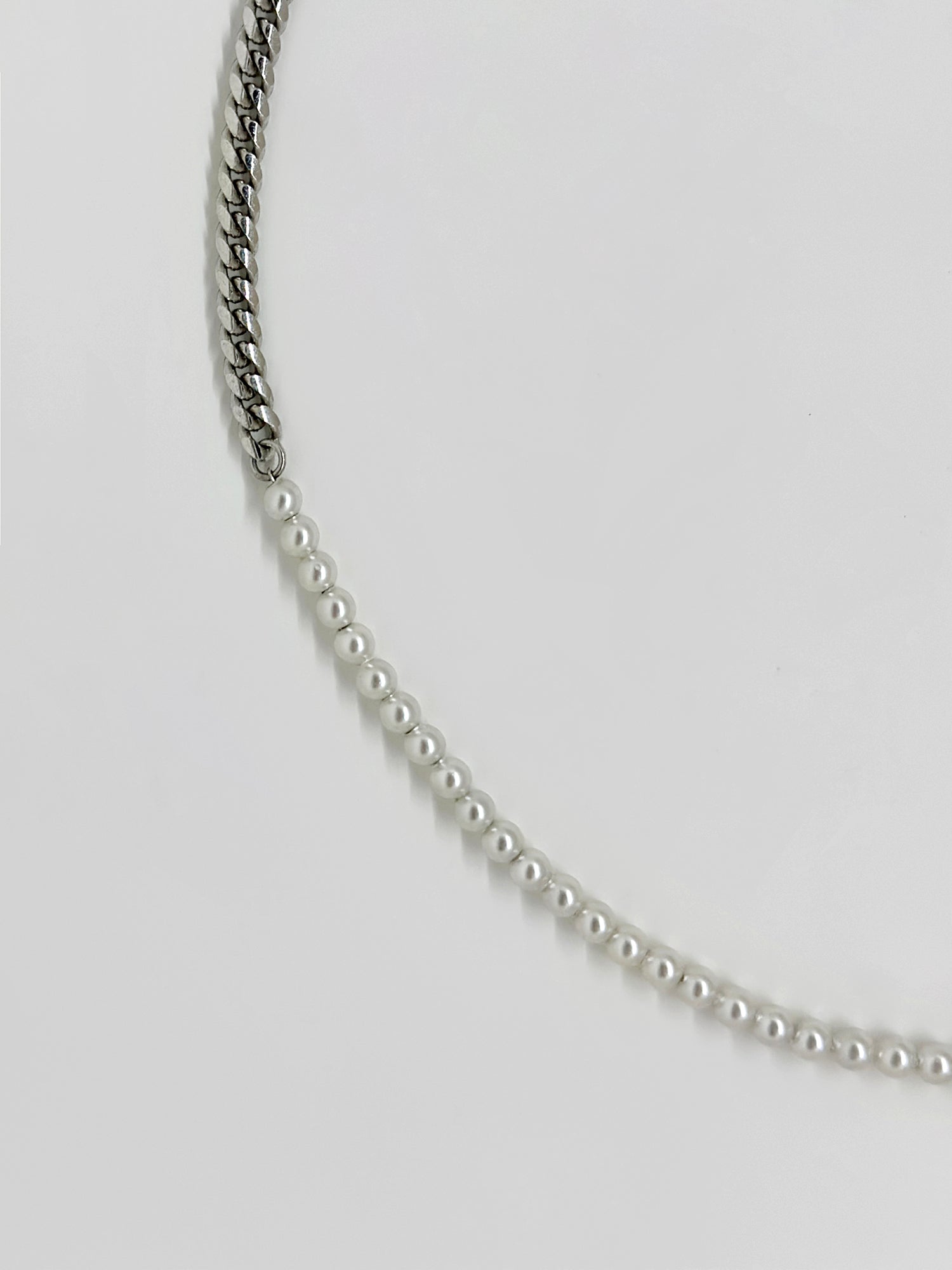 Zoom in on the diamond beaded necklace to see its exquisite combination of half pearls and metallic elements up close.