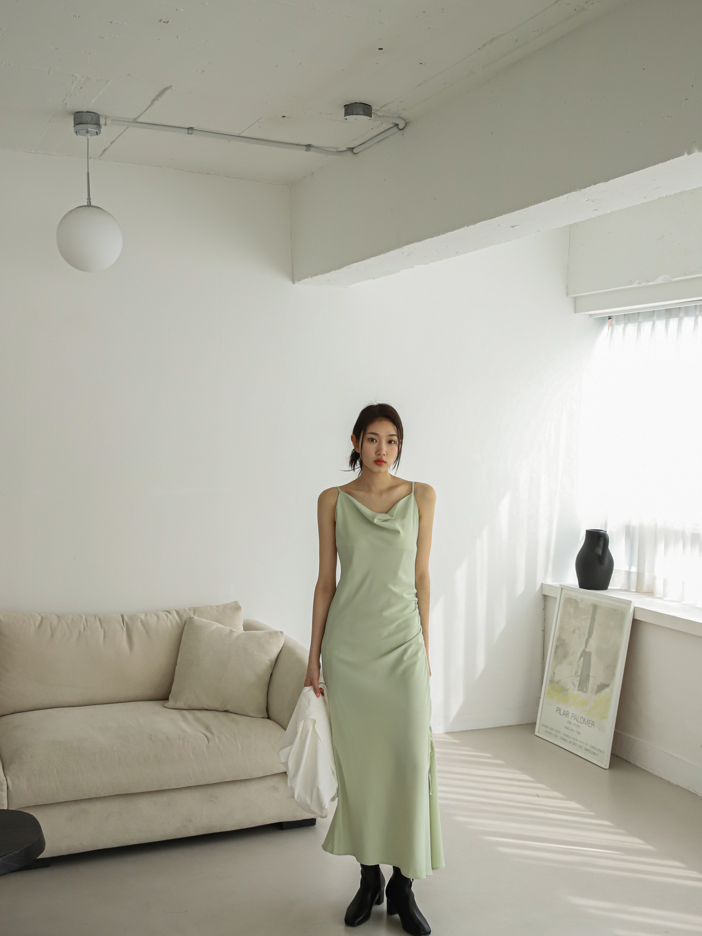 Long shot of a poised model wearing a maxi drawstring dress.