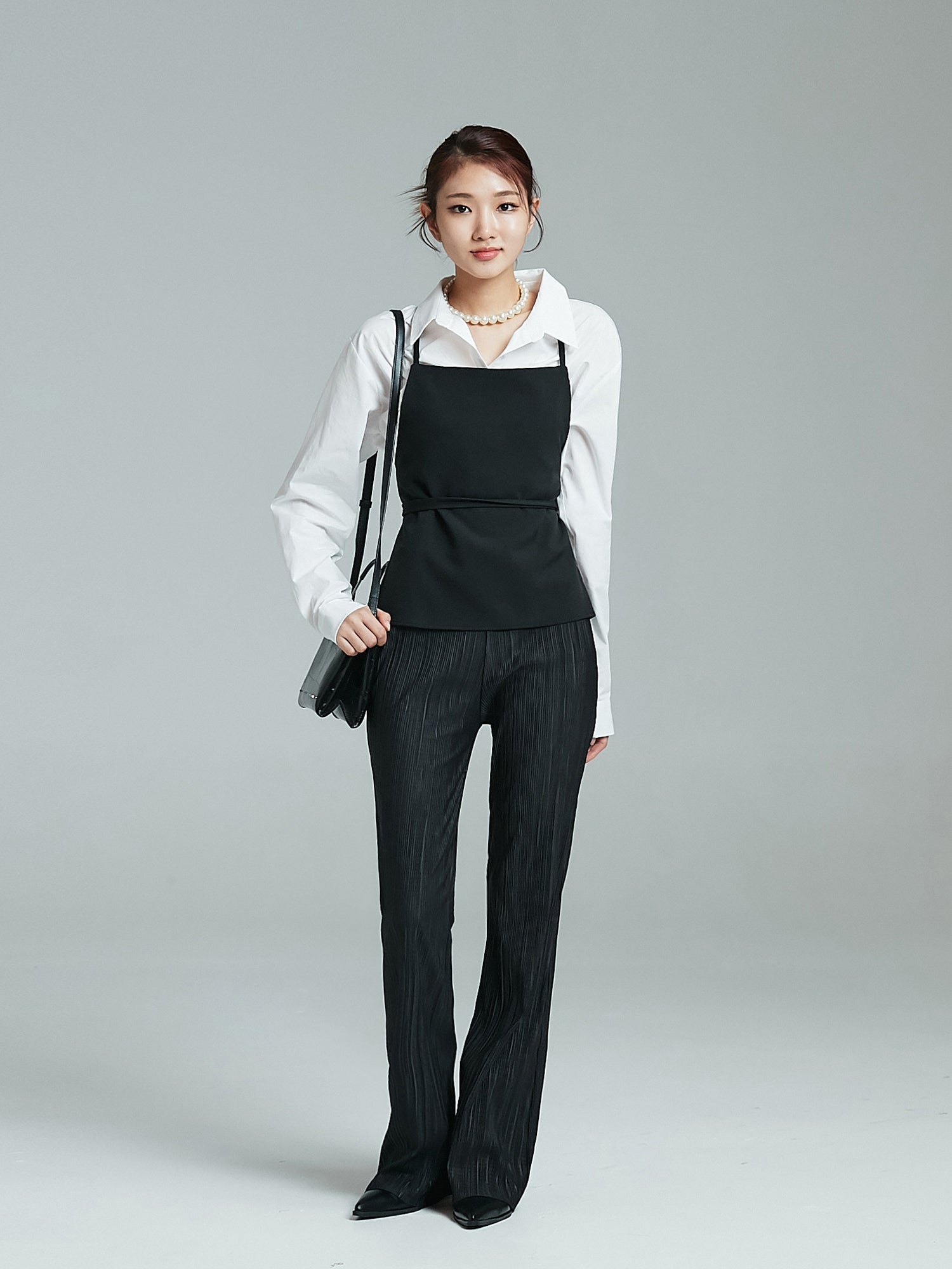 Front view of the model wearing the flare pleated pants to showcase its korean aesthetic outfits.