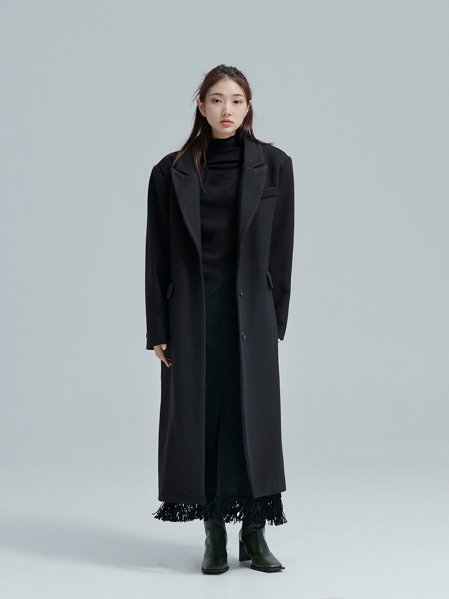 Front view of the model wearing the fringes coat showing off its classy coat of the korean street fashion.