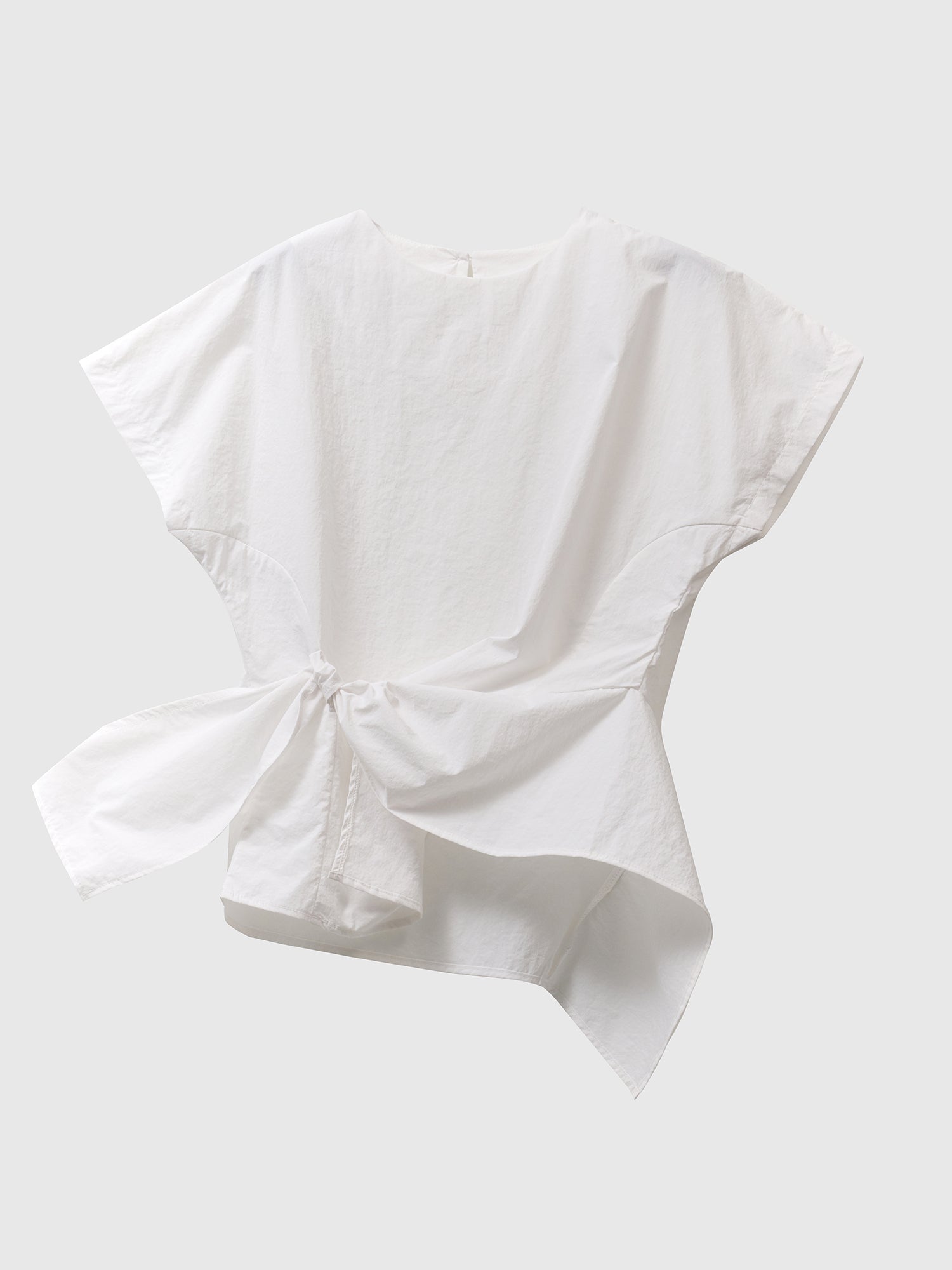 Product detailed view of the ivory front wrap blouse with white backdrop.