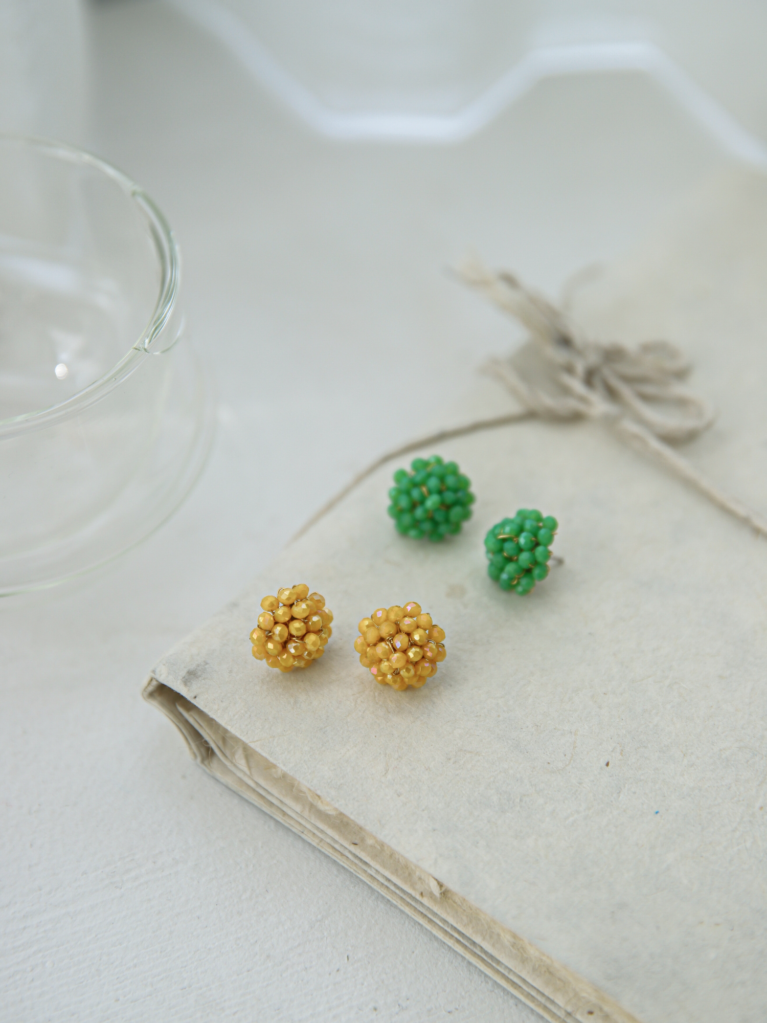 A picture of beaded earrings displaying yellow and green beaded earrings. 