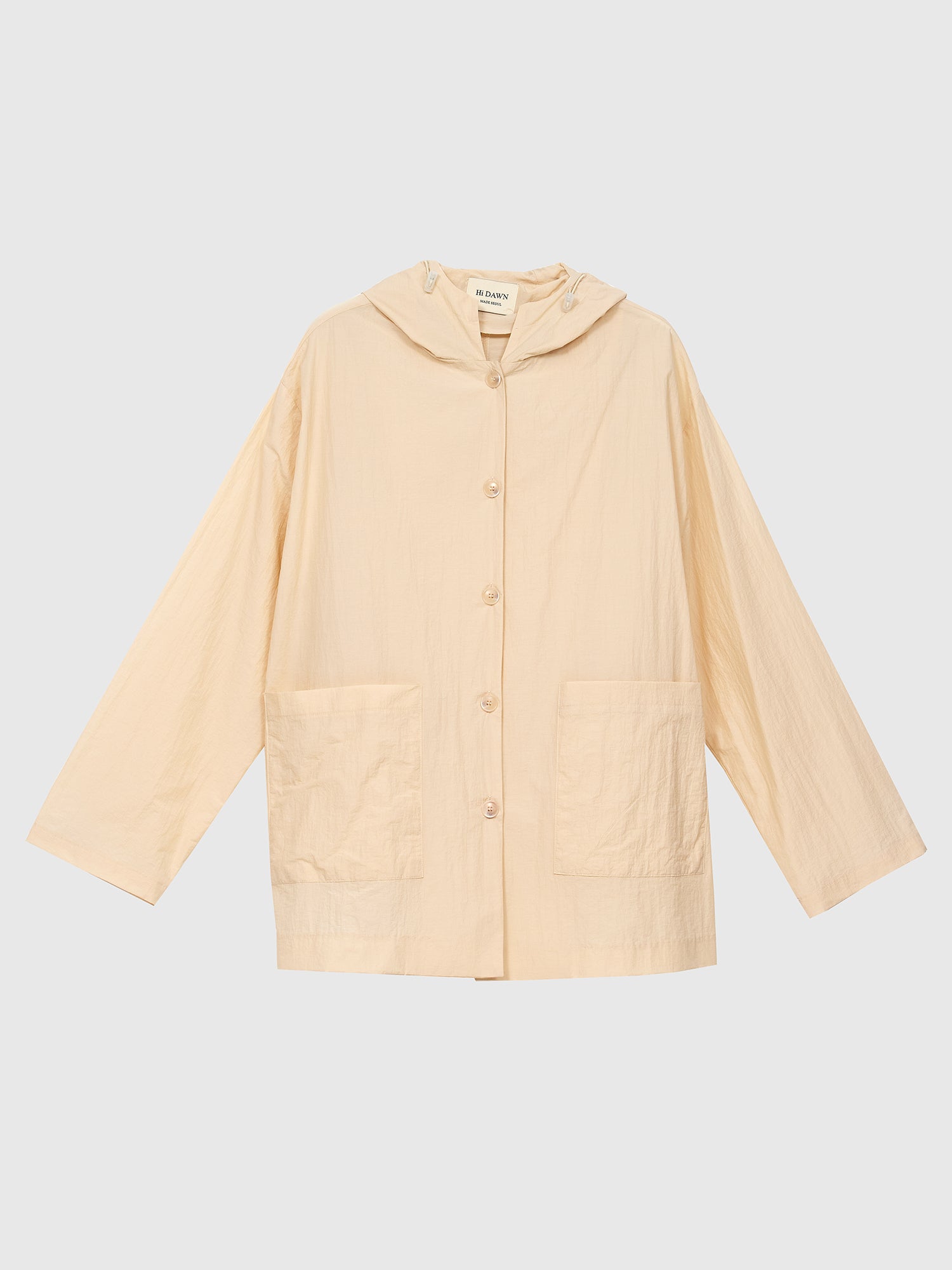 A product detailed view of the light beige hooded jacket, showcasing the intricate front detail and exemplifying its stylish appeal in the world of Korean street fashion.