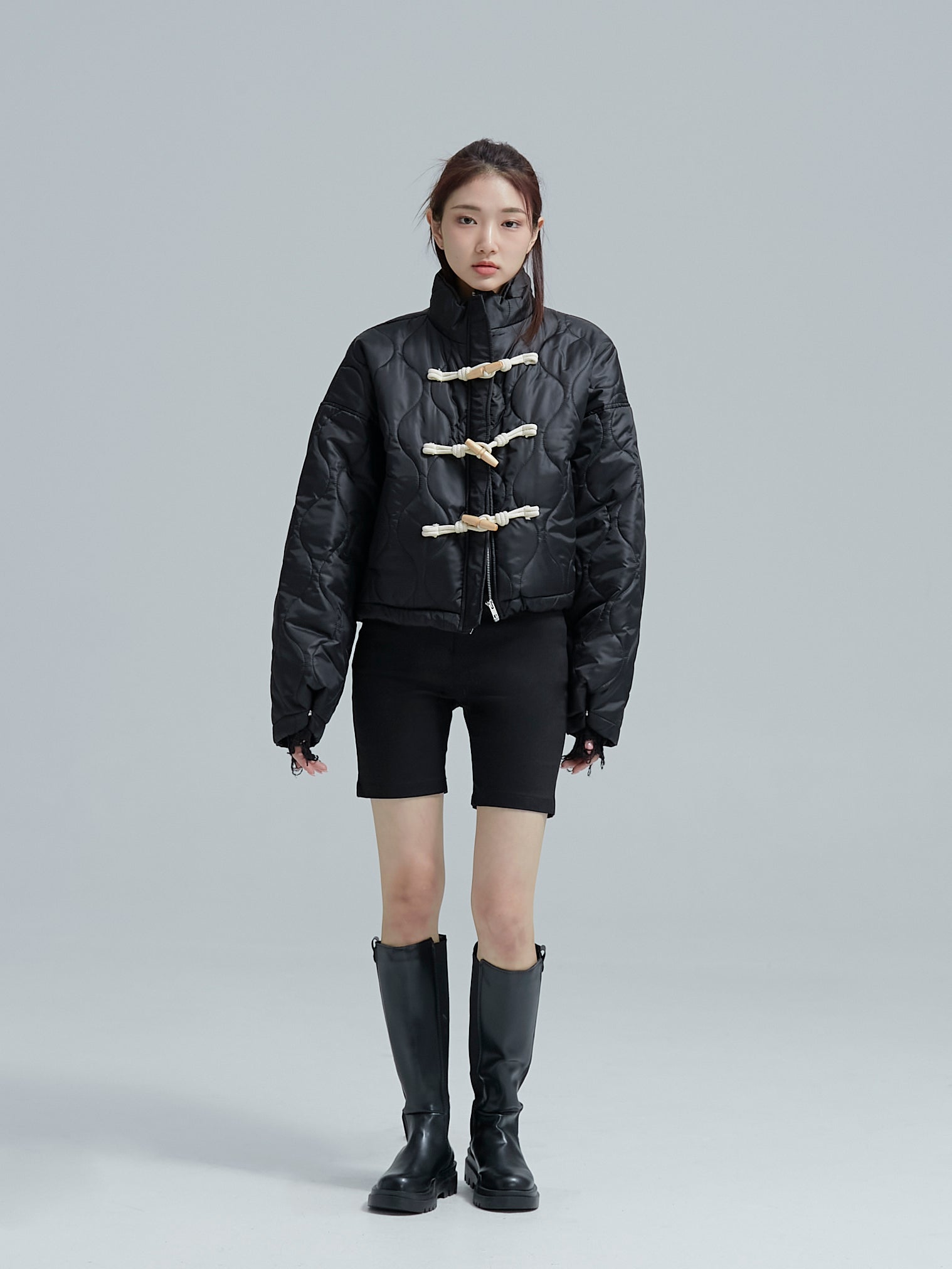 Full shot of the model wearing the black jaguar quilted jacket showing off its korean street style.