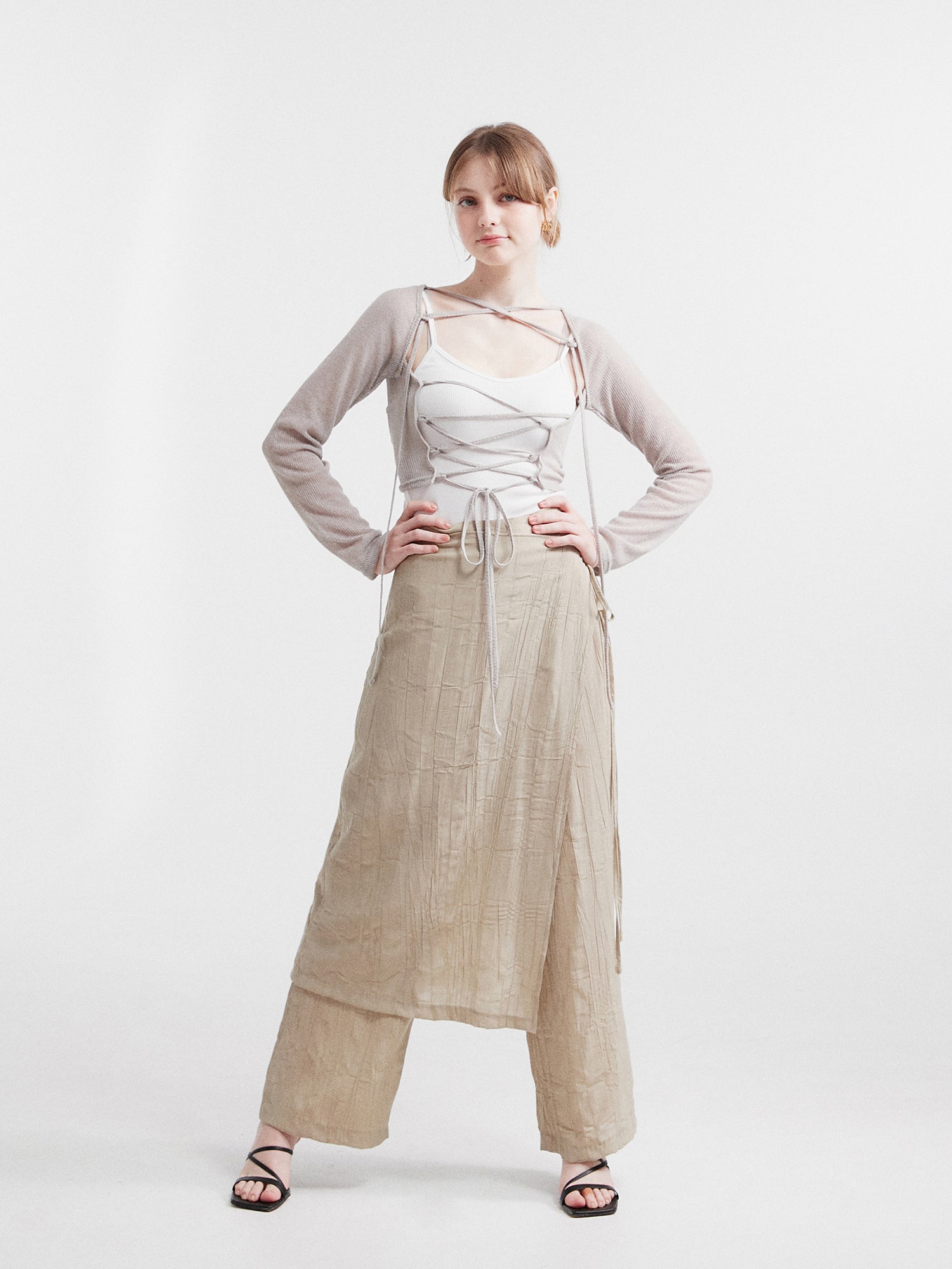 Full-shot of the model wearing the layered skirted pants to showcase the width of the pants.