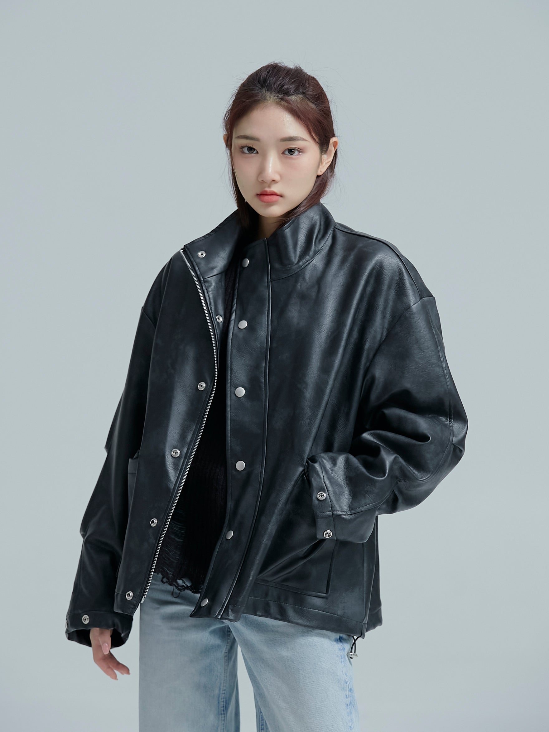 Front facing model wearing the Lined leather jacket, showing off the uniquely designed korean street fashion.