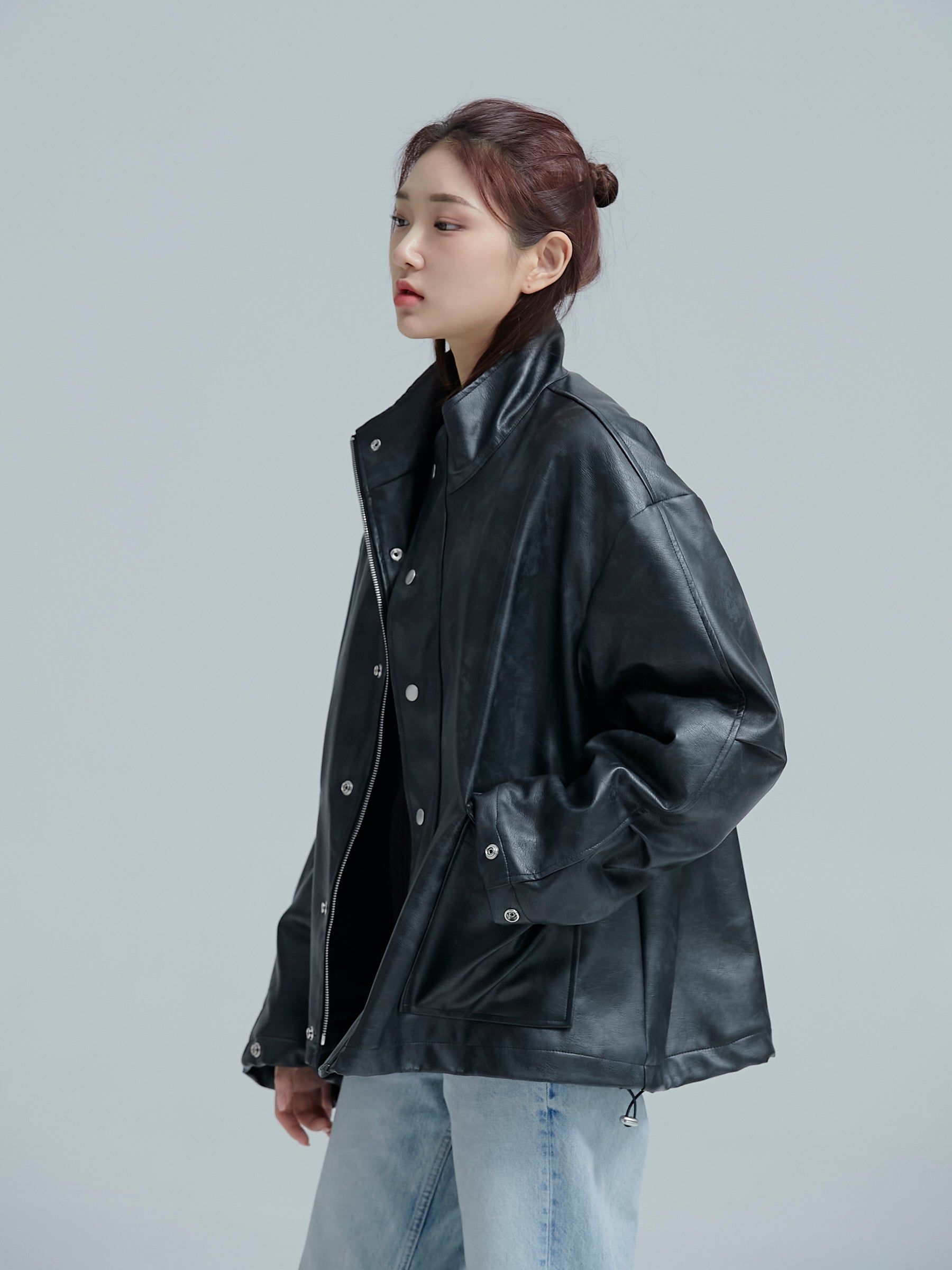 A side angle of the model wearing the Lined leather jacket showing off its korean street fashion aesthetics.