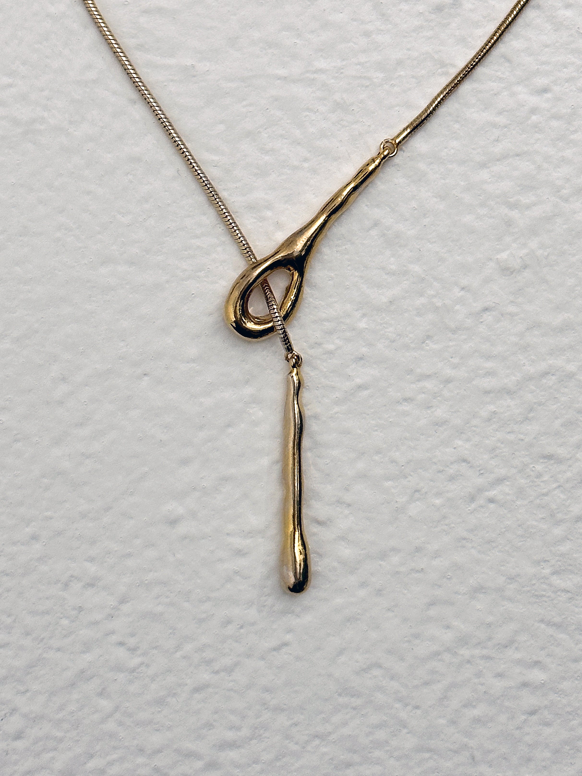 A zoomed-in view of the long chain drop necklace showing its clasps details.