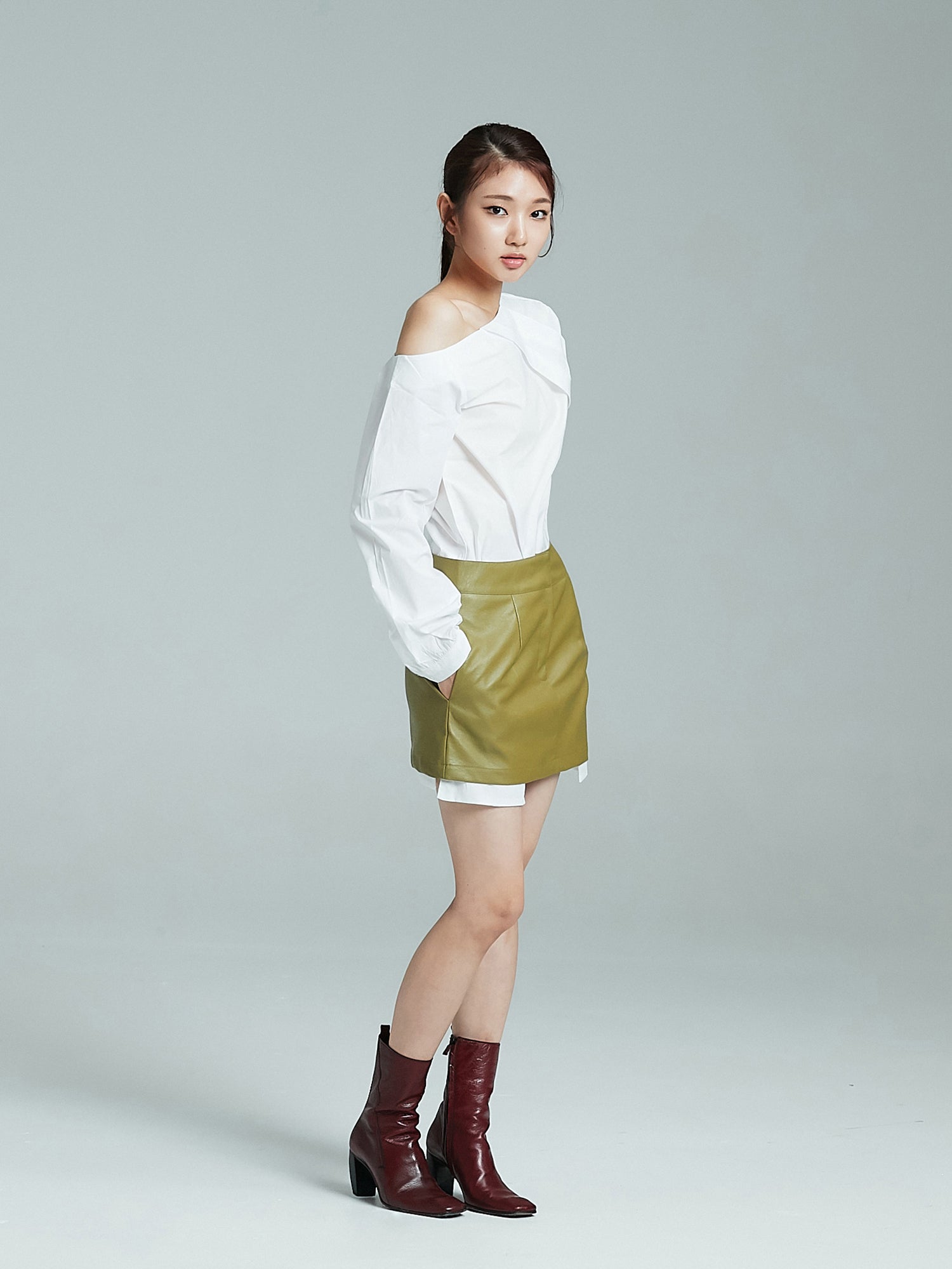 Side angle of the full-shot of the model wearing the one shoulder blouse showing the side look of the blouse.