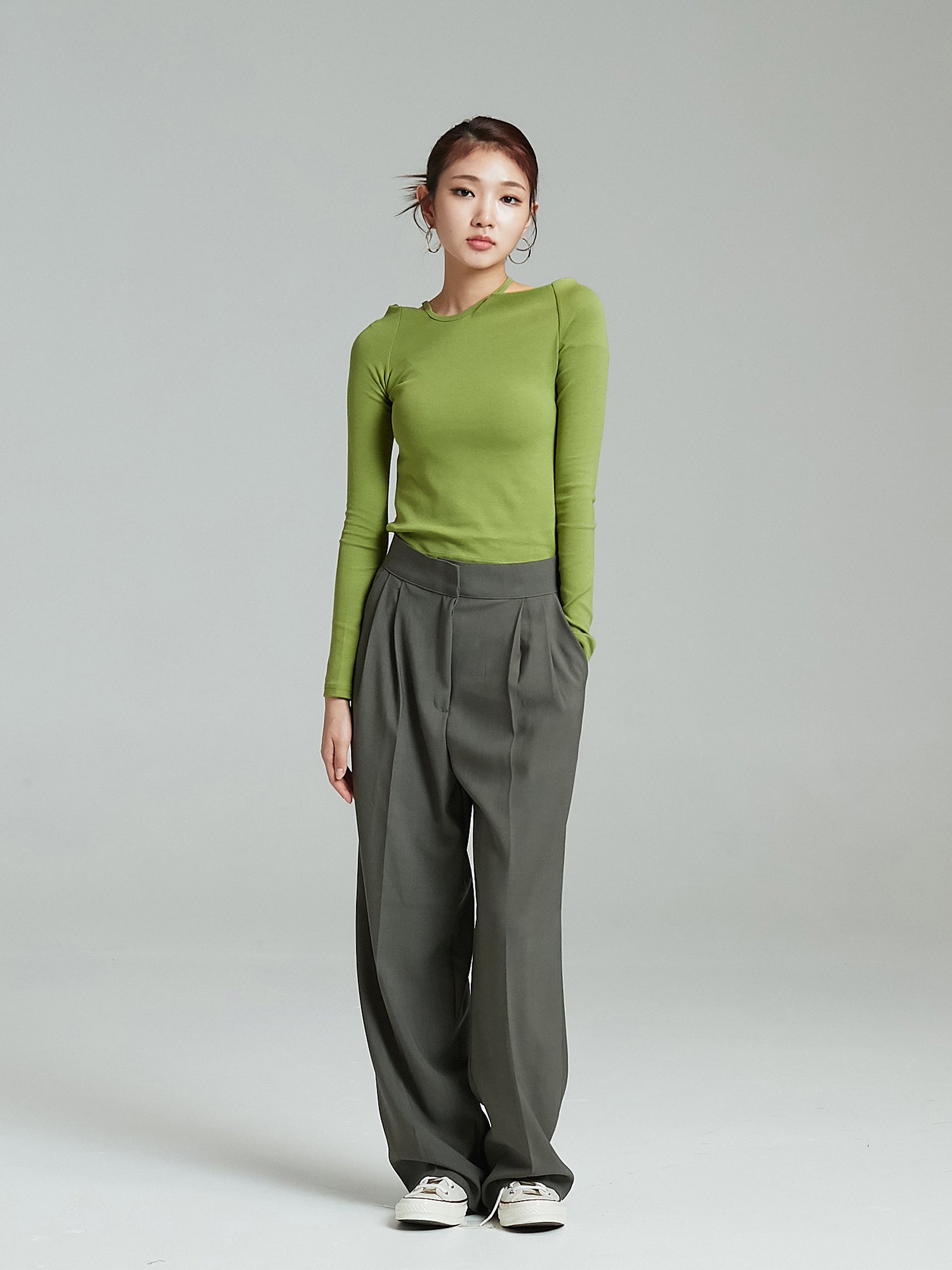 Full-shot of the model wearing the open shoulder top matched with trouser pants.