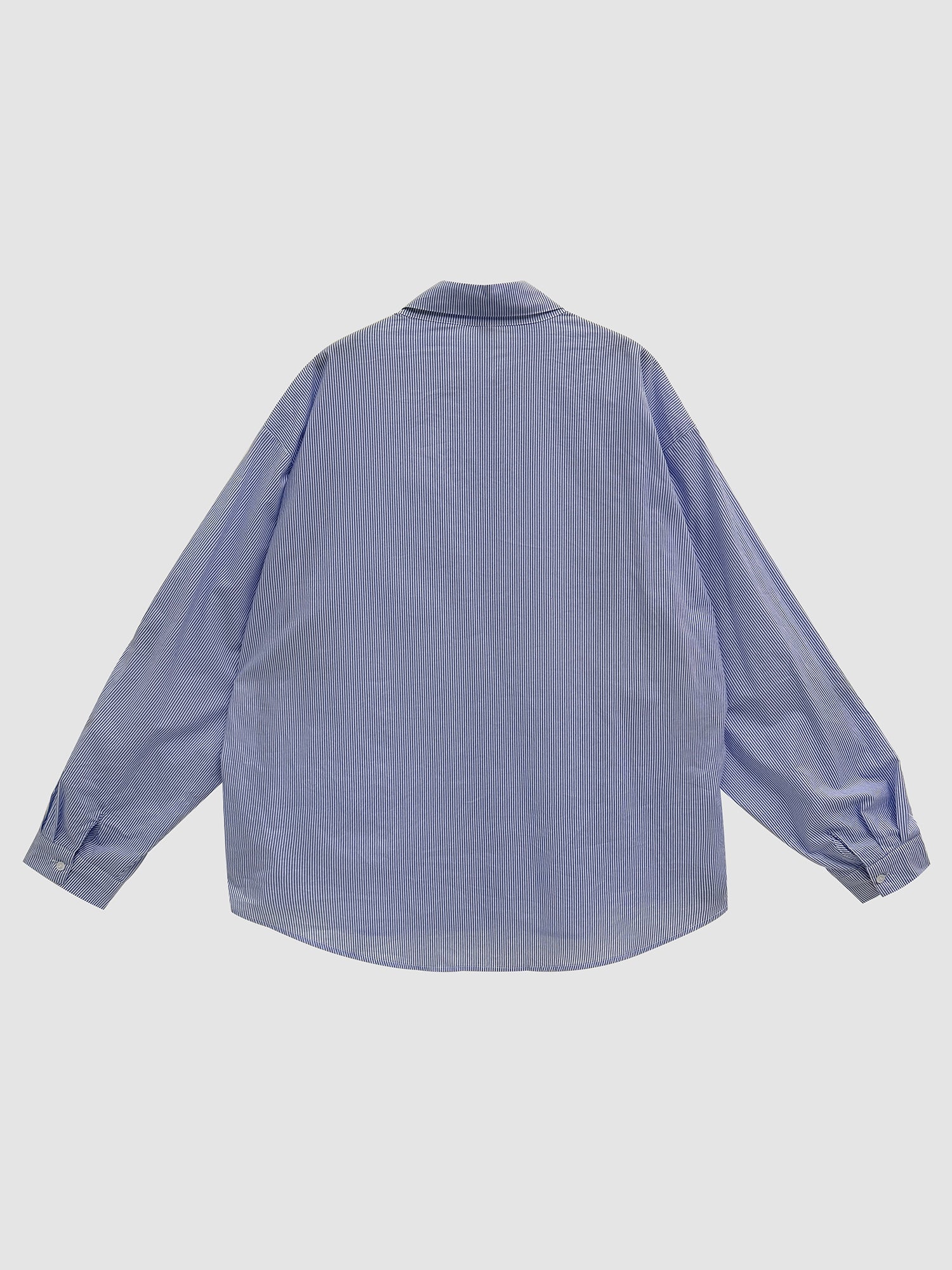 Back detailed view of the oversized shirt with gray backdrop.