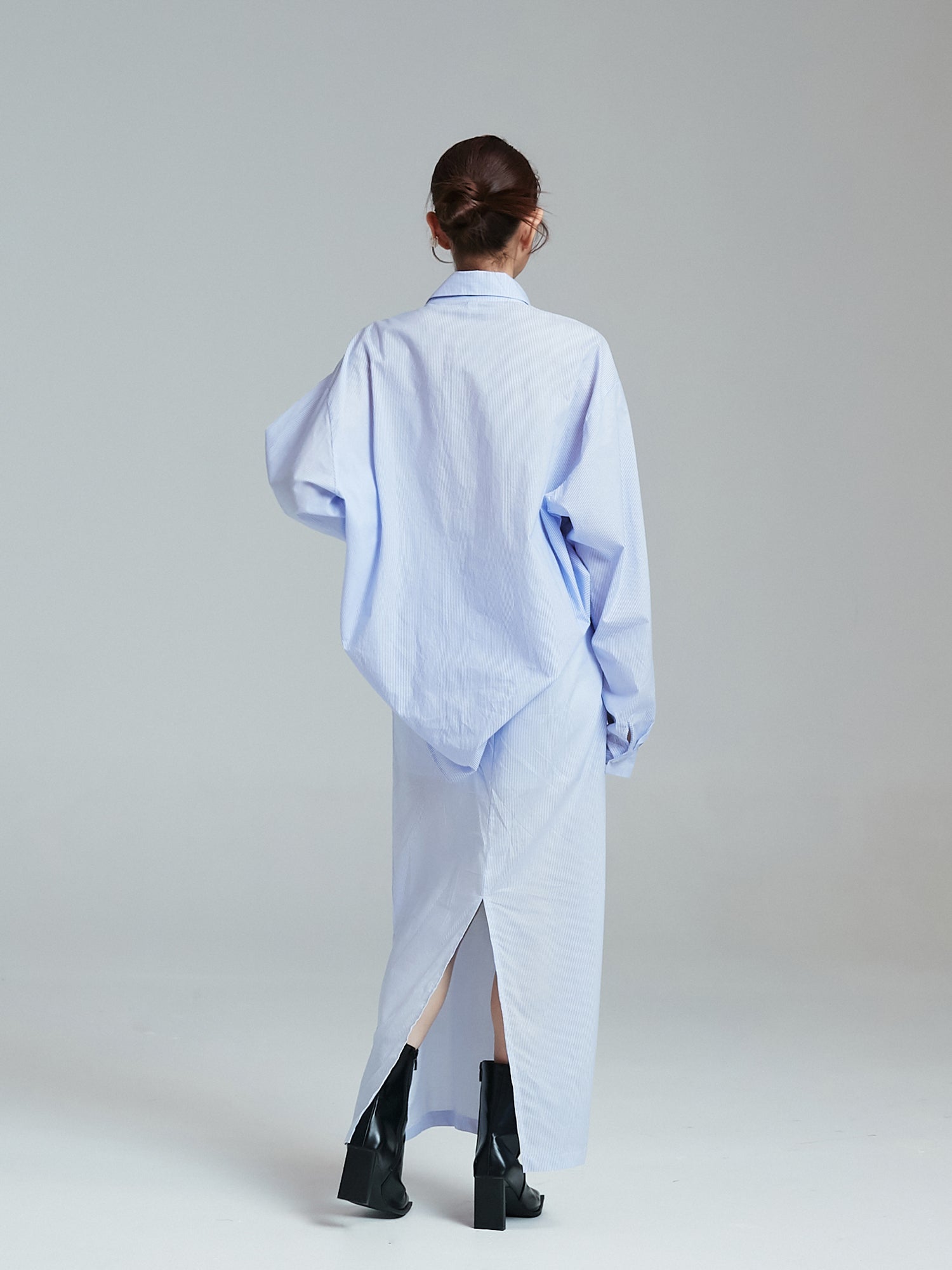 Back view of the model wearing the oversized shirt.