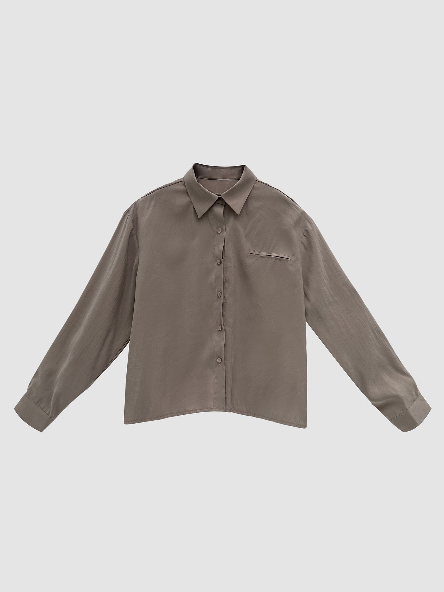 Front detailed view of the taupe oversized suede shirt with gray backdrop.