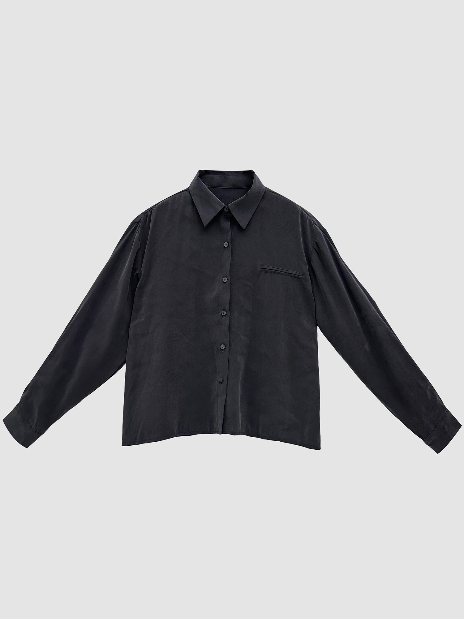 Front detailed shot of the charcoal oversized suede shirt showing its korean street fashion vibe.