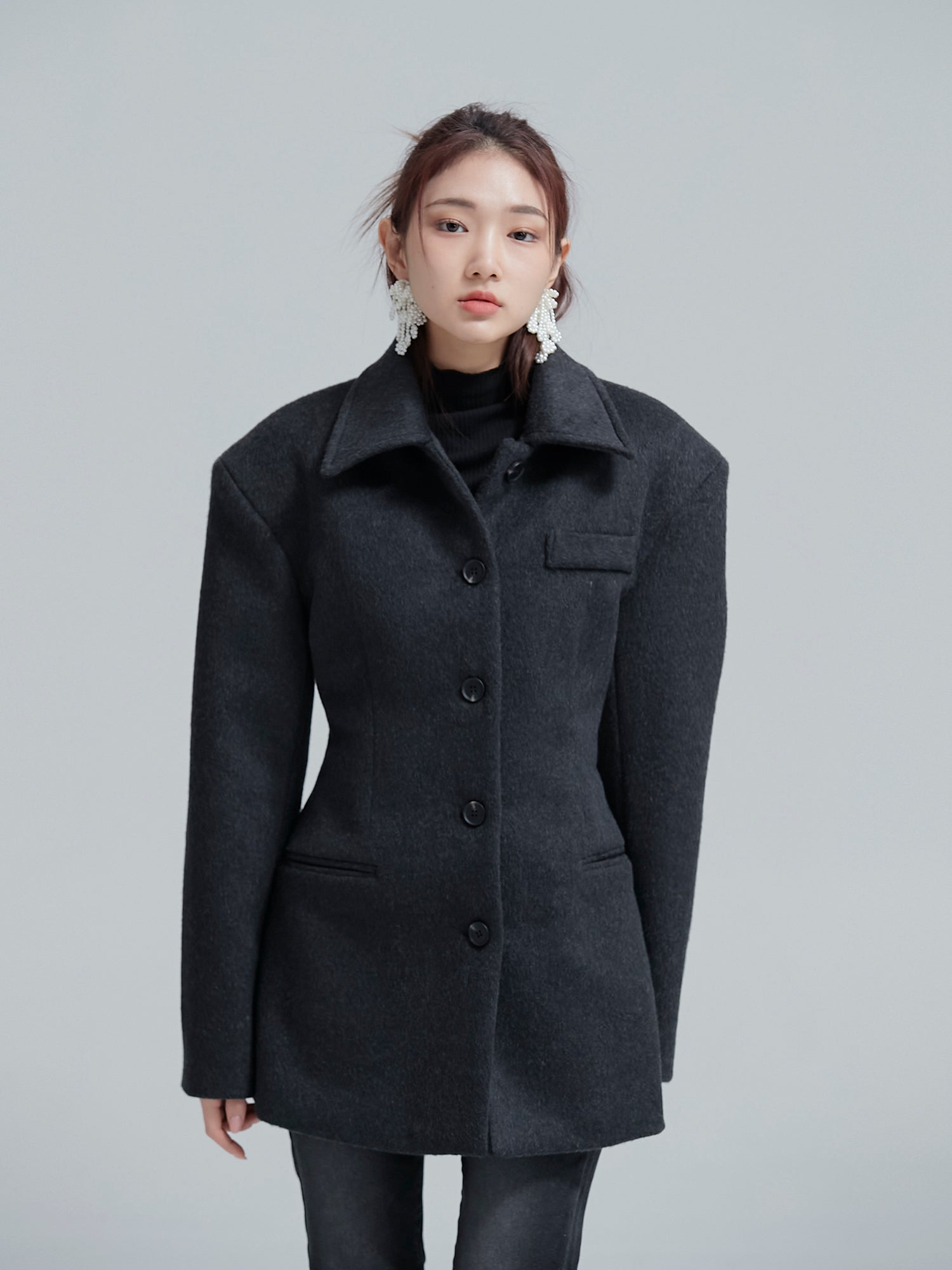 A frontal view of the model in the padded fitted coat, spotlighting its chic Korean street style vibes.