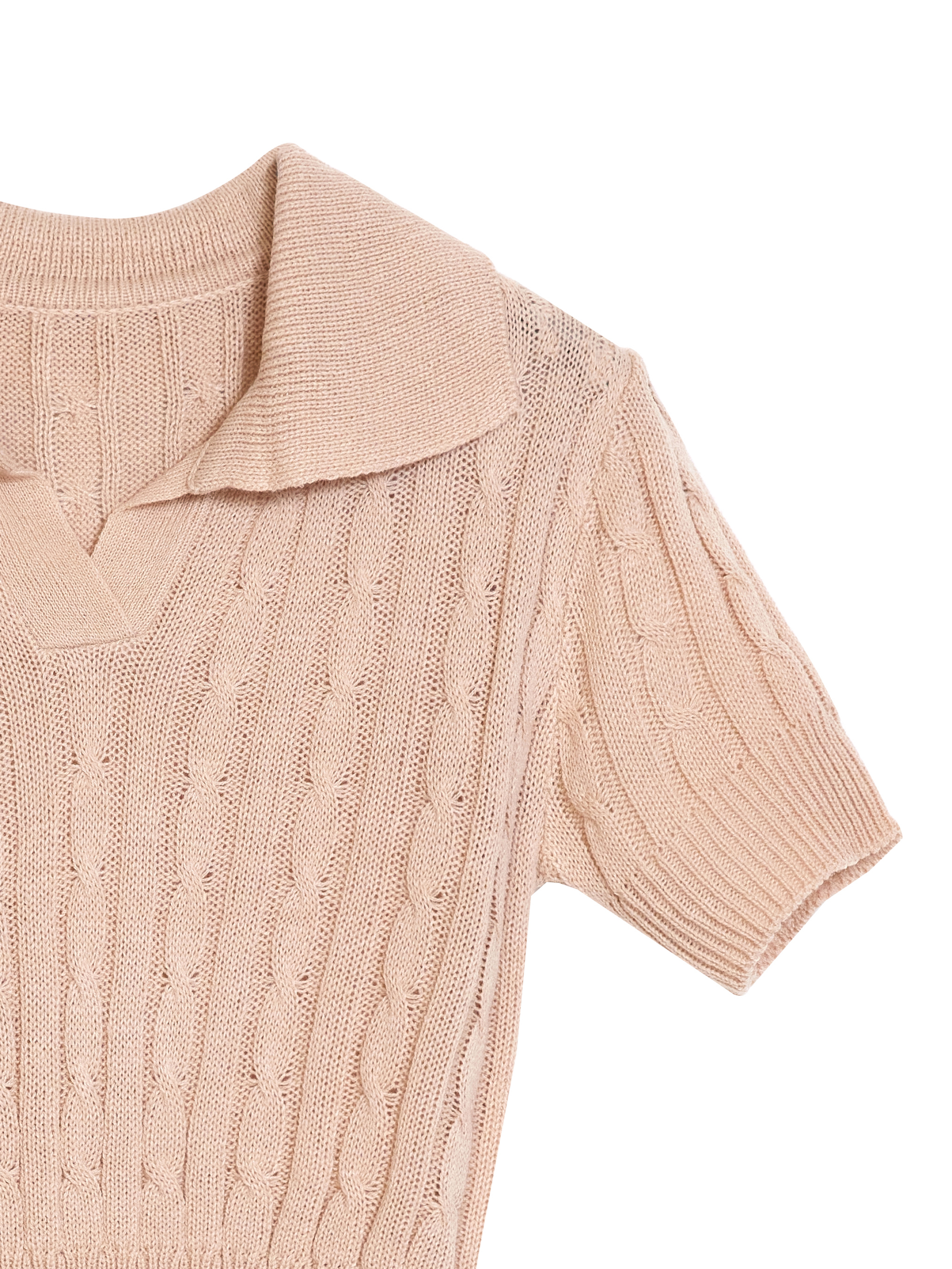 A zoomed-in shot of the beige polo knit shirt highlighting the fabric and its detailed designs of the knit shirt.