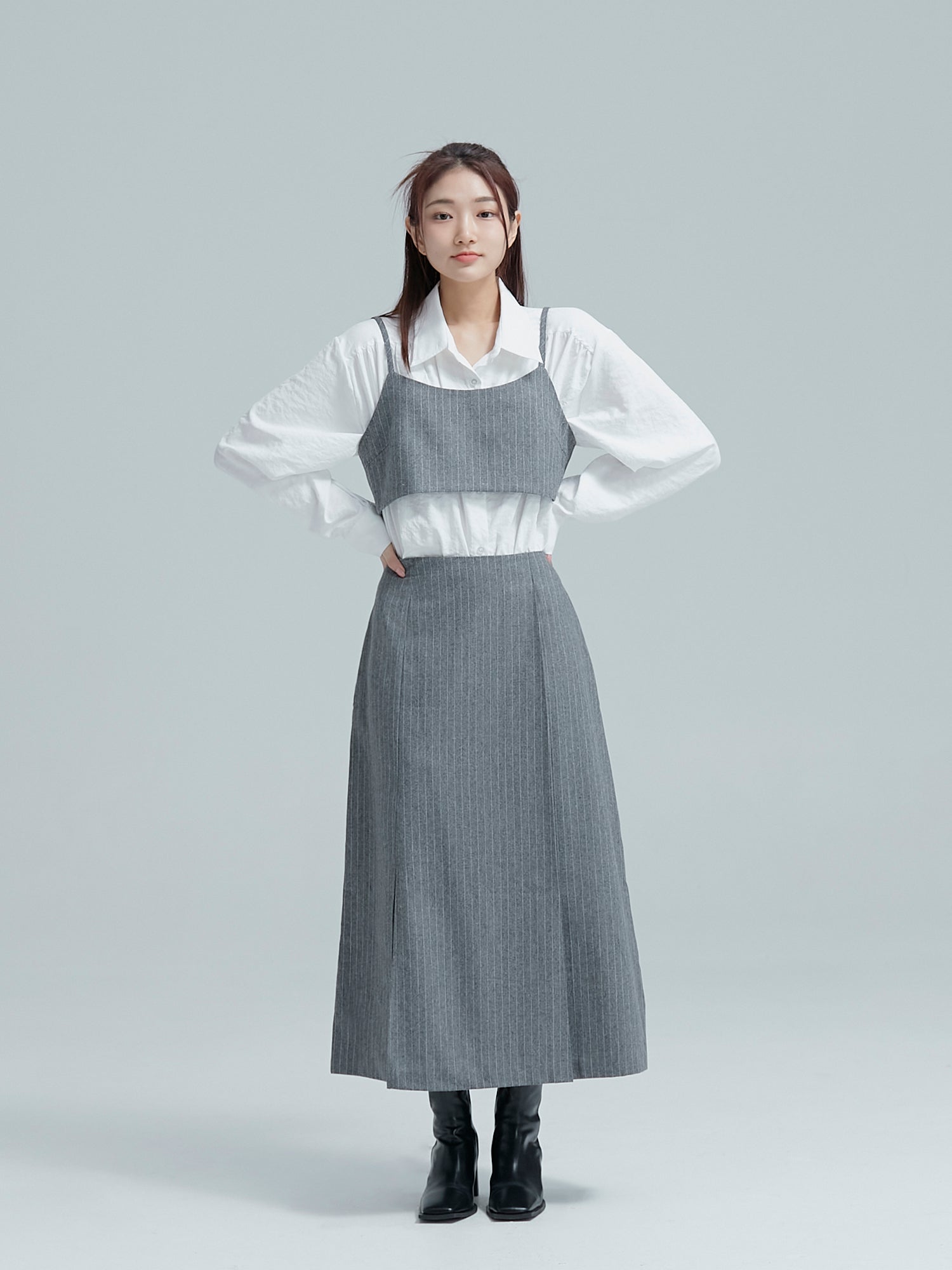 Front shot of the model with her hands on her waist while wearing the relaxed classy shirt to accentuate its korean aesthetic outfits vibe.