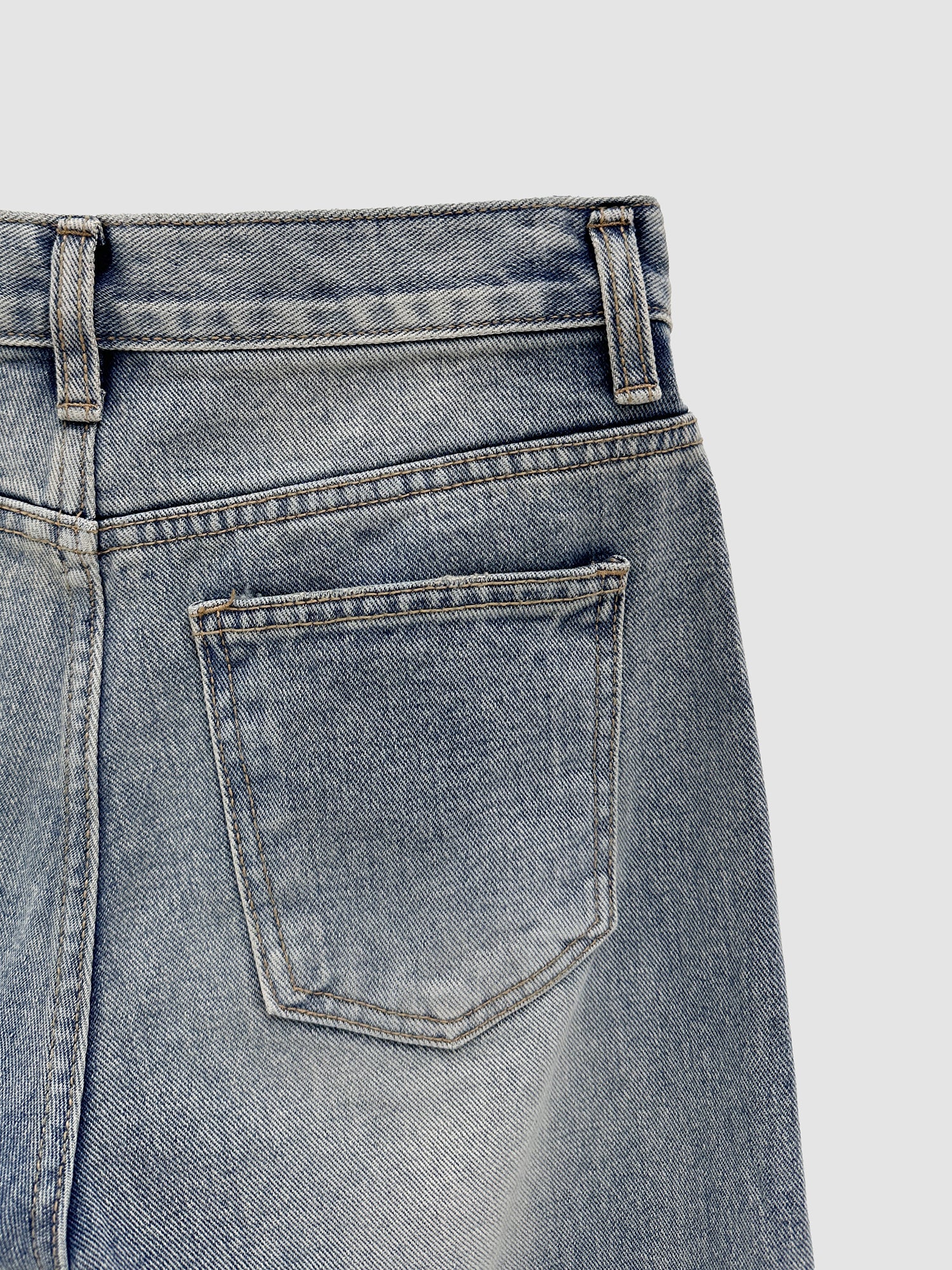 A close-up shot of the back pocket of the Relaxed Wash Jeans showing the intricate seam stitching and fabric of the jeans.