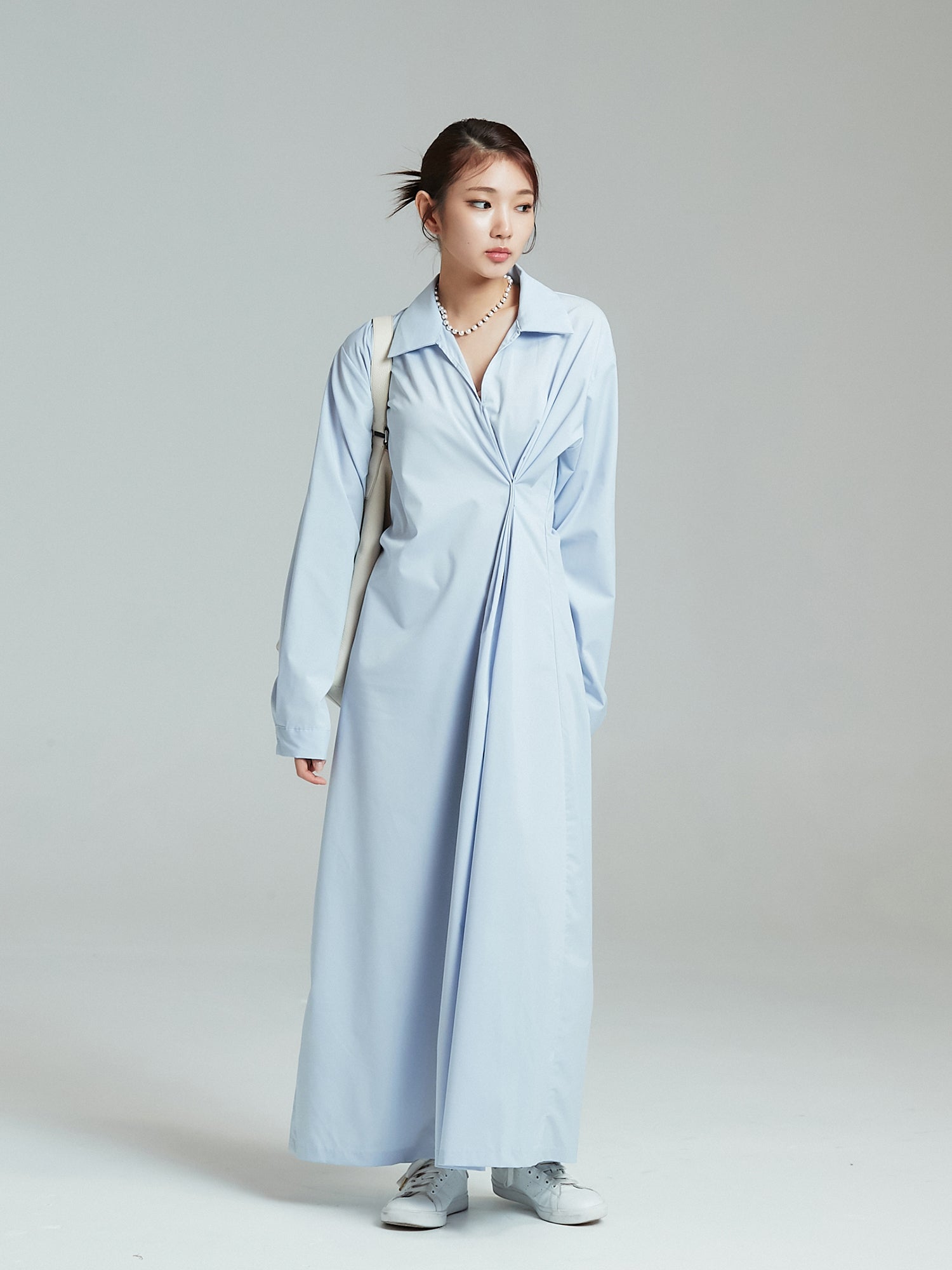 Model looking to the side showcasing the light blue shirring maxi dress.