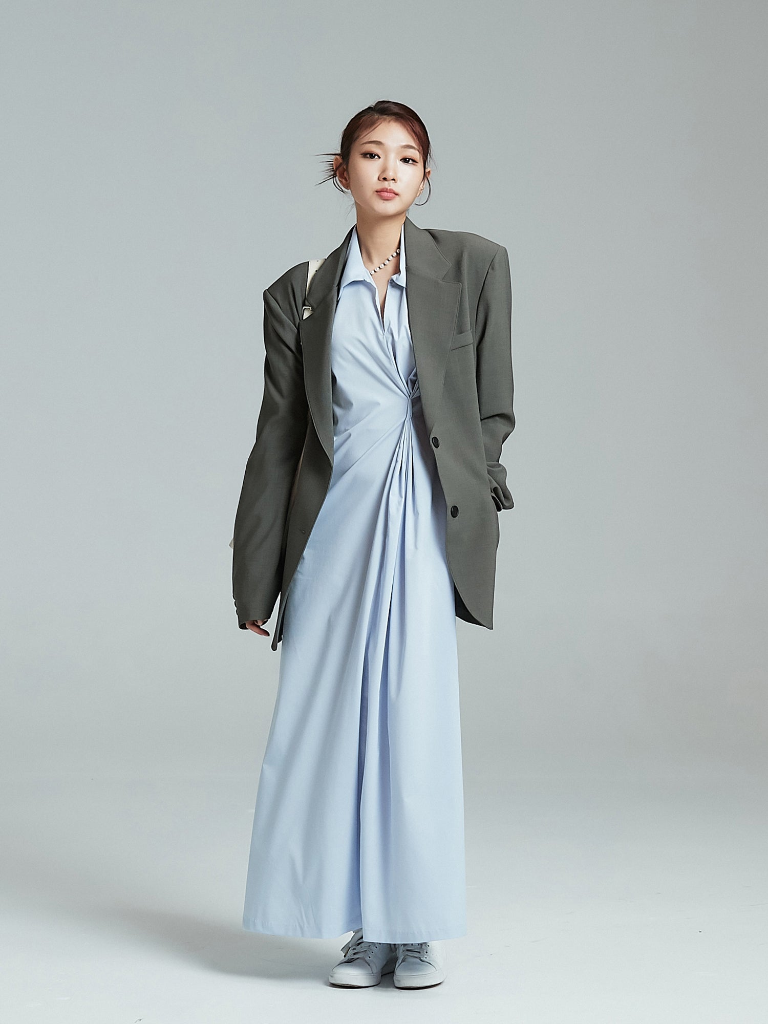 A frontal view showcasing the model wearing the shirring maxi dress, elegantly paired with an oversized blazer to enhance the Korean aesthetic outfits.