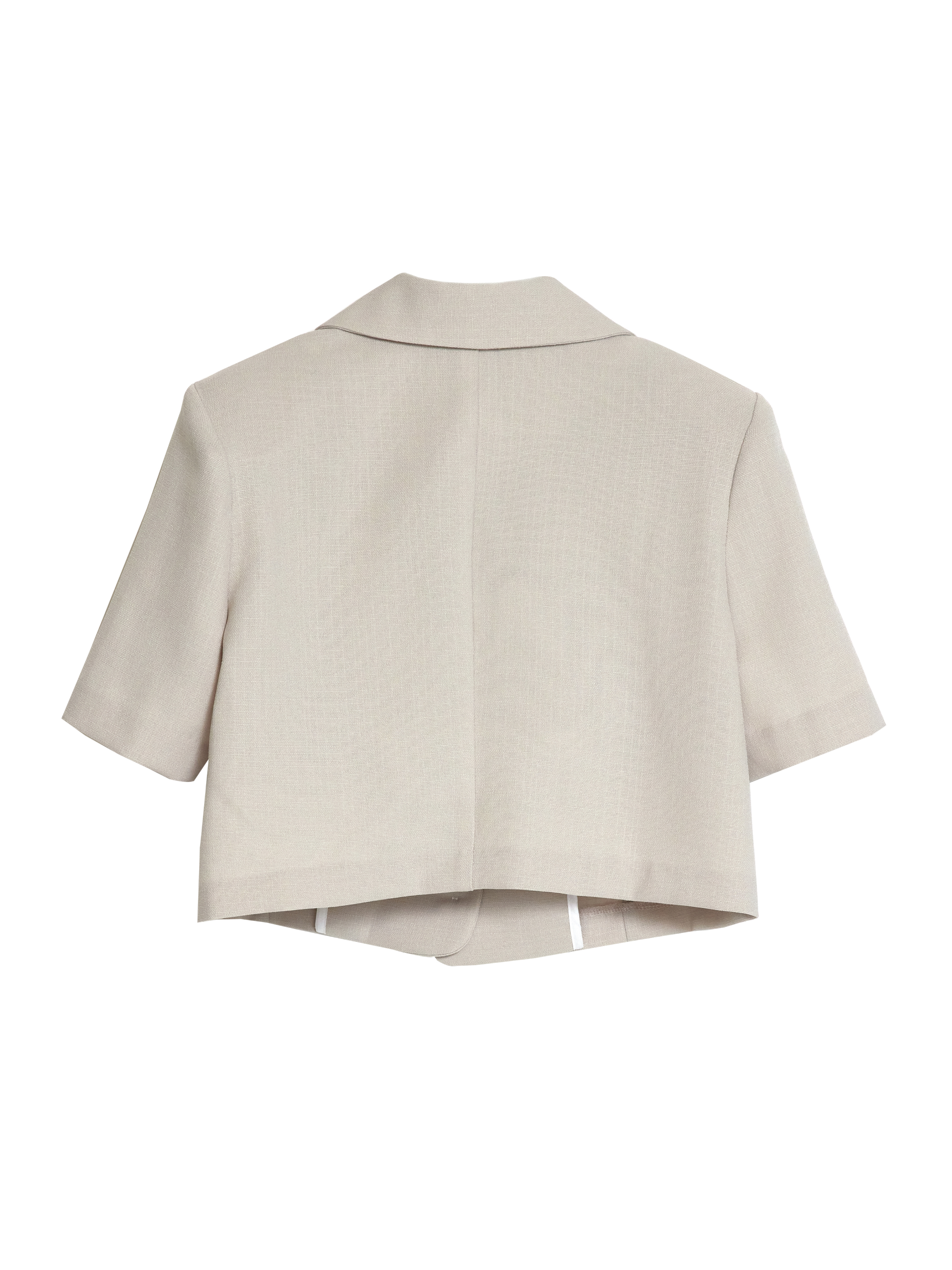 It captures the back side of the light beige short-sleeve blazer with white backdrop.