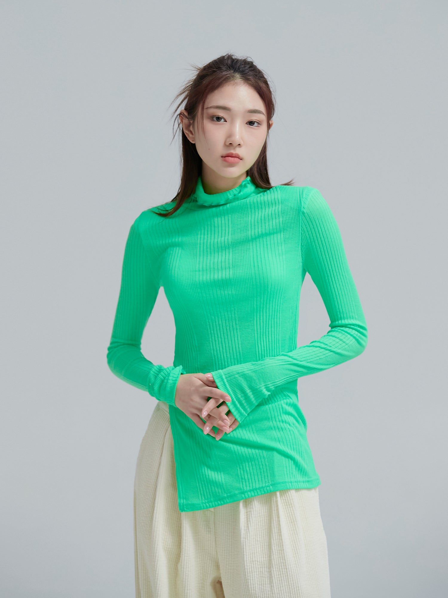 Front shot of the model posing while wearing the neon green slit ribbed neck top that accentuate its aesthetics of the korean street style.