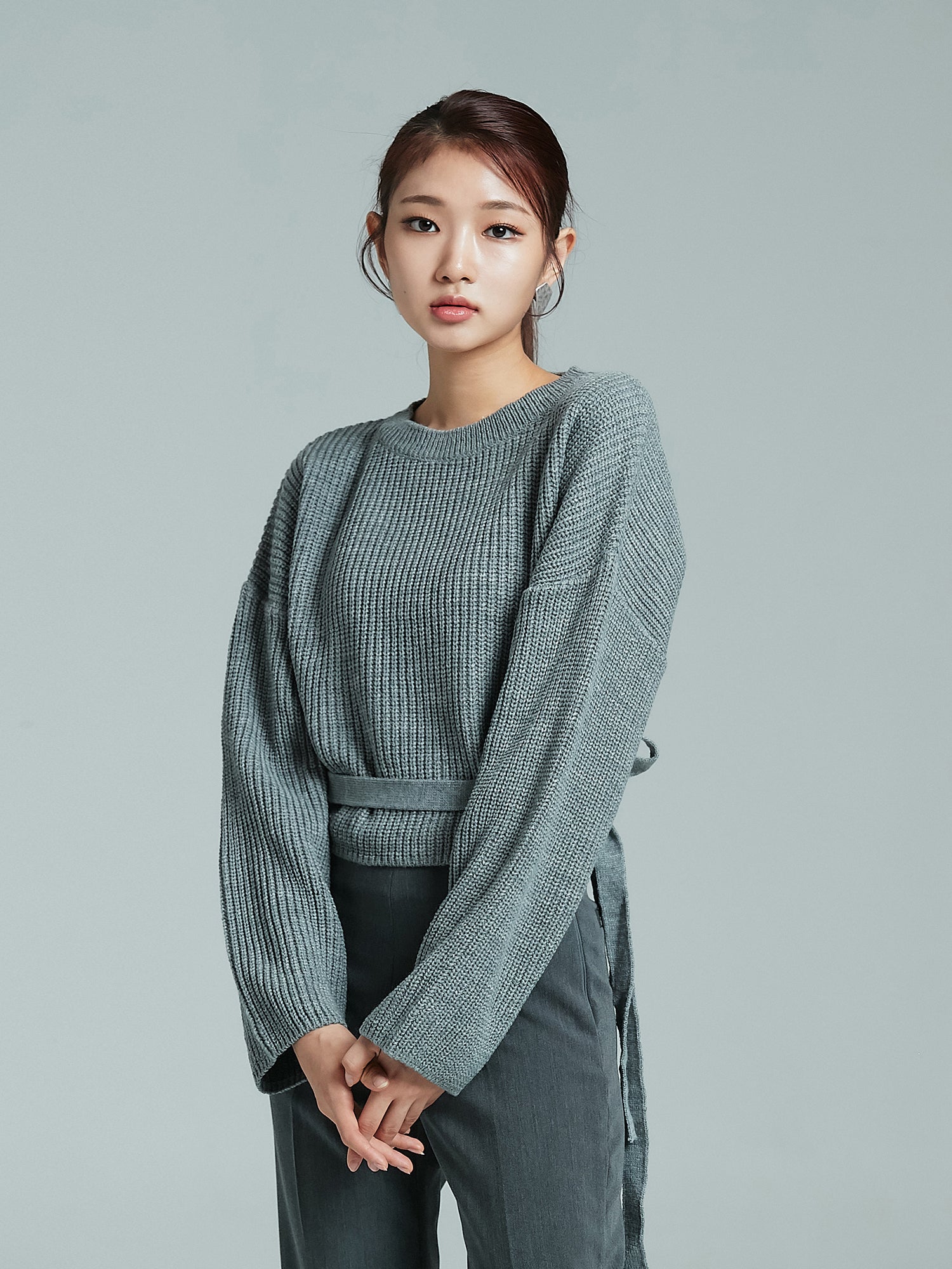 Tilted look of the model wearing the sloane sweater showing the side look of the sweater.