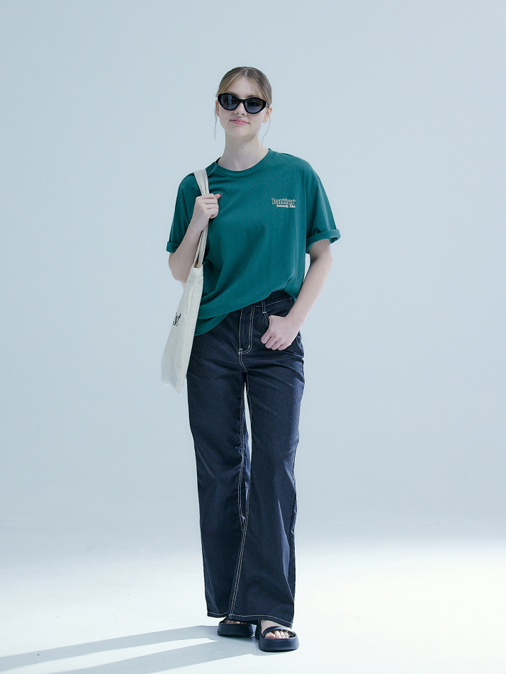 Full-shot of the model wearing the smooth like butter t-shirt paired with chic wide-leg denim jeans. 